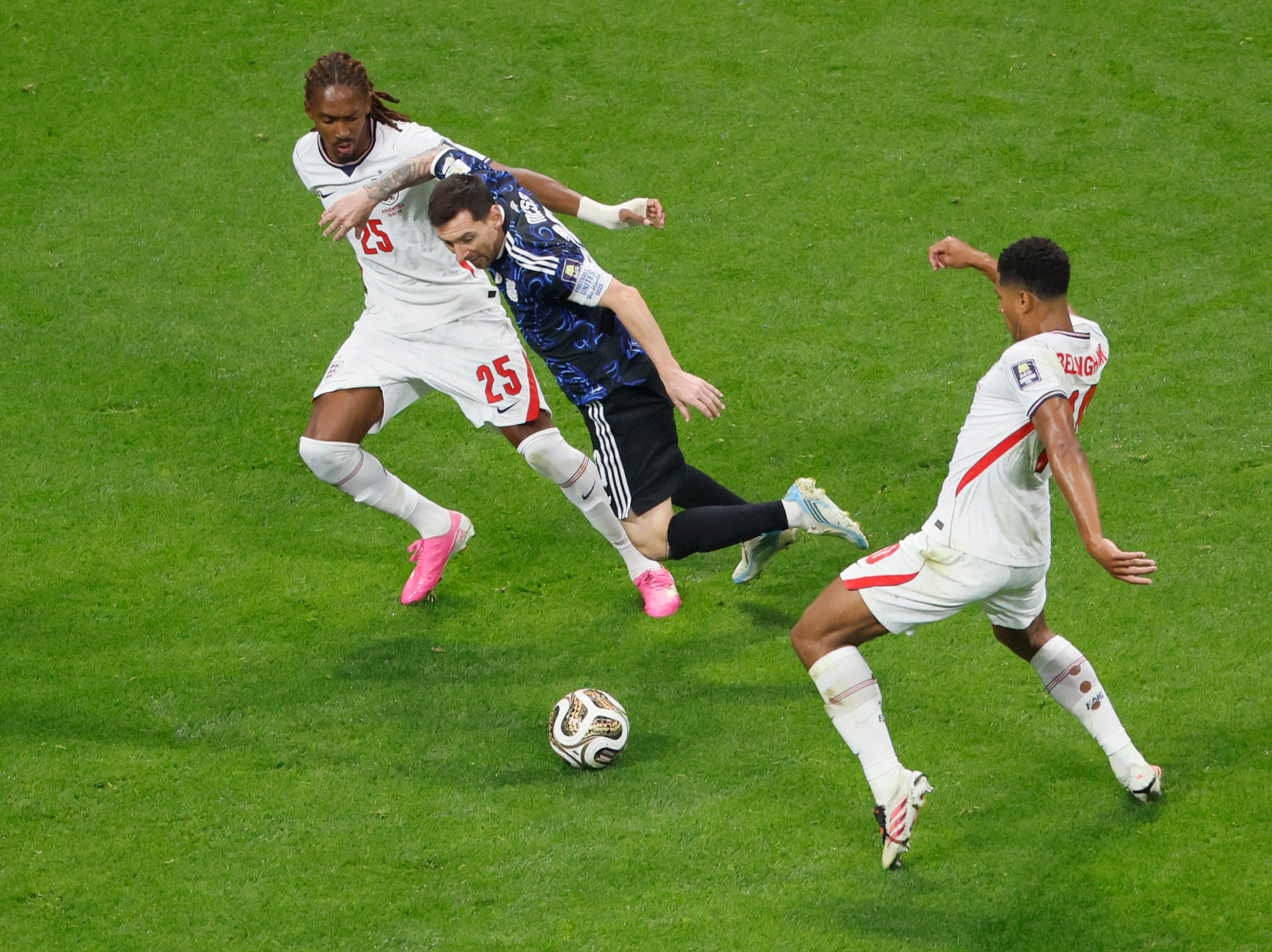 Argentina's Lionel Messi goes flying between England's Djed Spence, left and England's Jude Bellingham during first half of Argentina vs. England FIFA World Cup Semifinal match at Atlanta Stadium (Mercedes-Benz Stadium) on Wednesday, July 15, 2026. (Miguel Martinez/AJC)