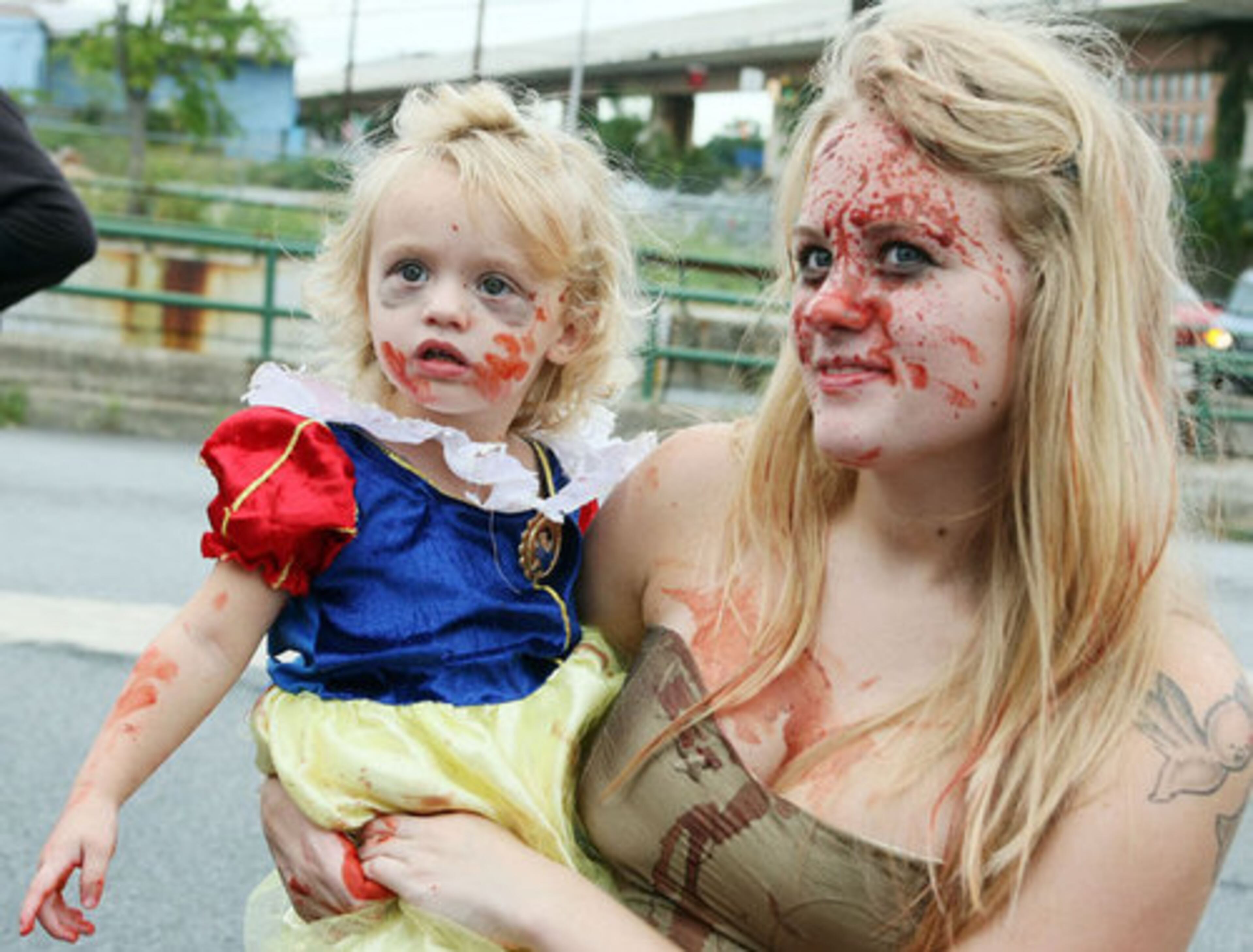 Two-year-old Paisley Allen doesn't know what to think as she and her mother, Amanda, wait for the walk to begin.