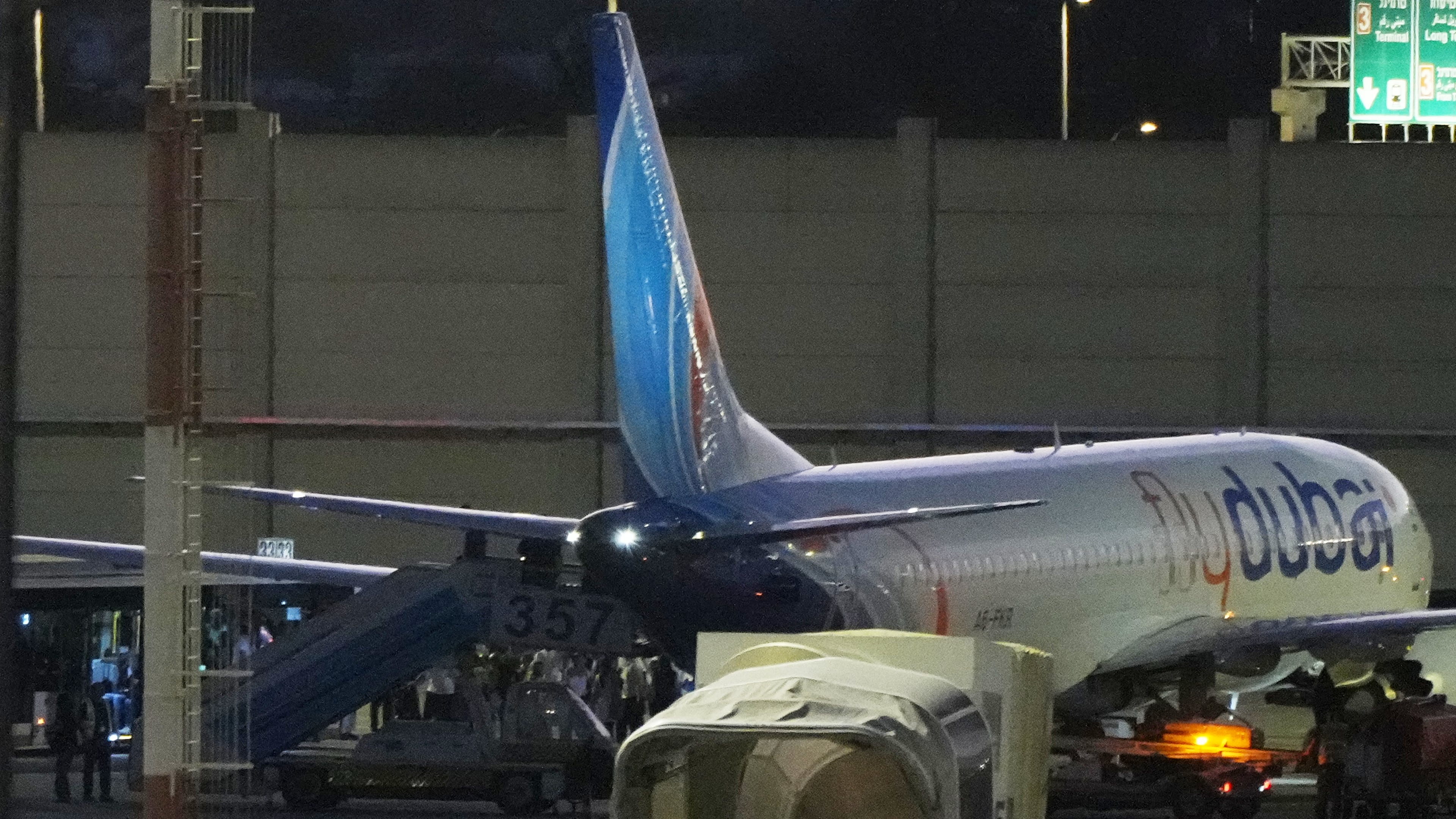 People disembark from a FlyDubai carrying Israeli passengers who had earlier been aboard another FlyDubai aircraft that made an emergency landing in Saudi Arabia approaches Ben Gurion International Airport near Tel Aviv, Israel, Wednesday, Sept. 30, 2026. (AP Photo/Ariel Schalit)