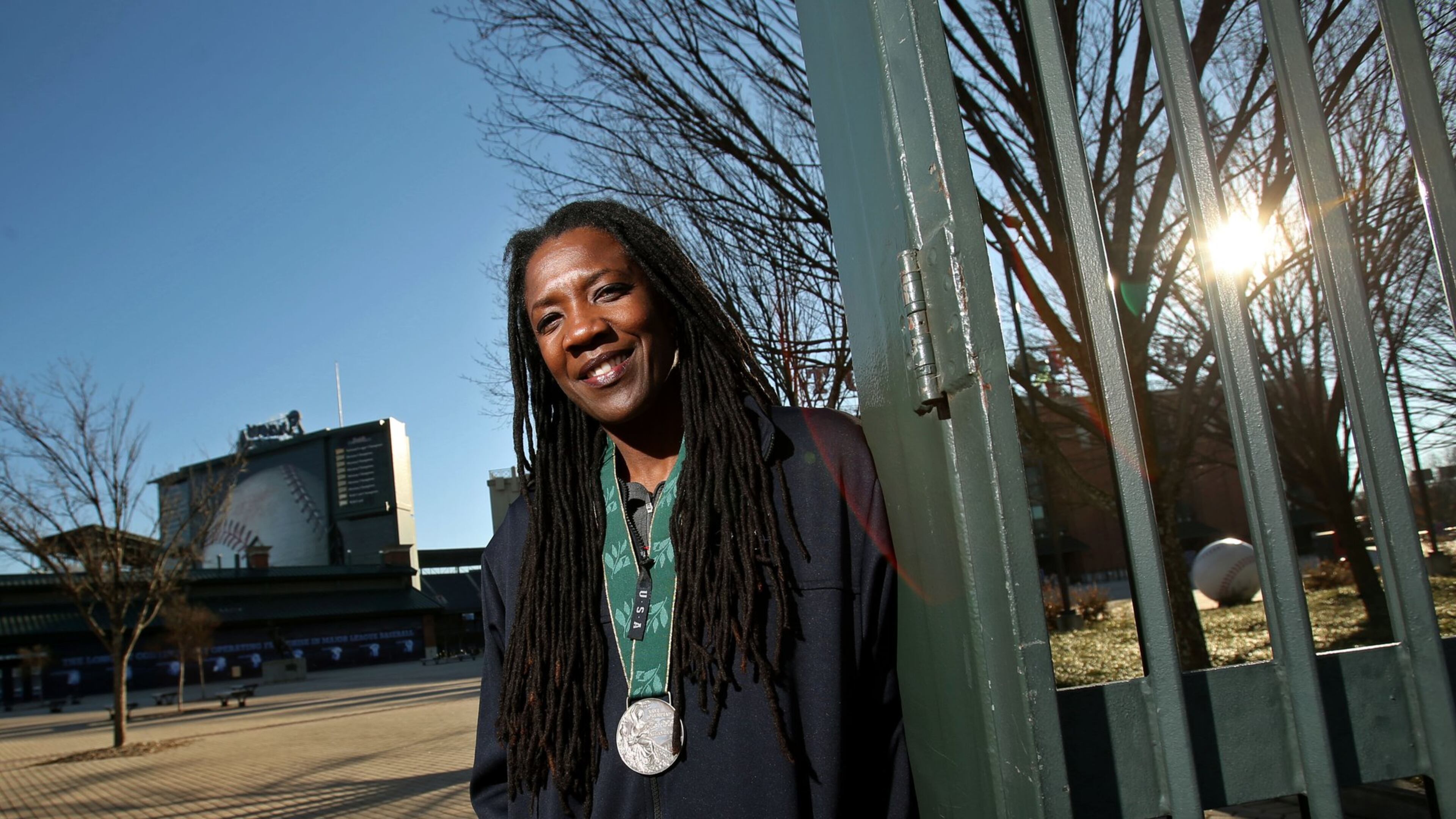 U.S. Olympian Kim Batten wears her silver metal from the 1996 Olympic games outside of Turner Field Thursday afternoon in Atlanta, Ga., December 12, 2013. Batten won her first and only Olympic medal, a silver in the 400 meter hurdles, at the ‘96 Games here in Atlanta. She is upset that there is a strong possibility that Turner Field/Olympic Stadium will be torn down in 2017.