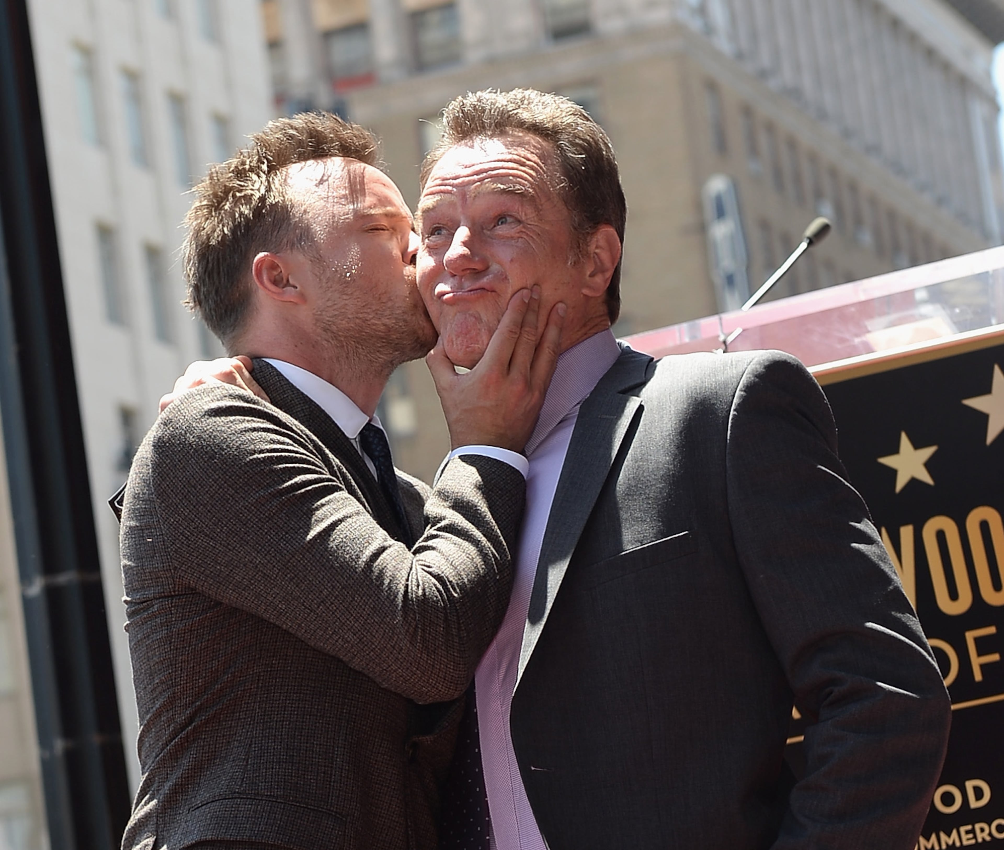 HOLLYWOOD, CA - JULY 16: Actor Aaron Paul (L) kisses actor Bryan Cranston on the Hollywood Walk of Fame on July 16, 2013 in Hollywood, California. (Photo by Michael Buckner/Getty Images)