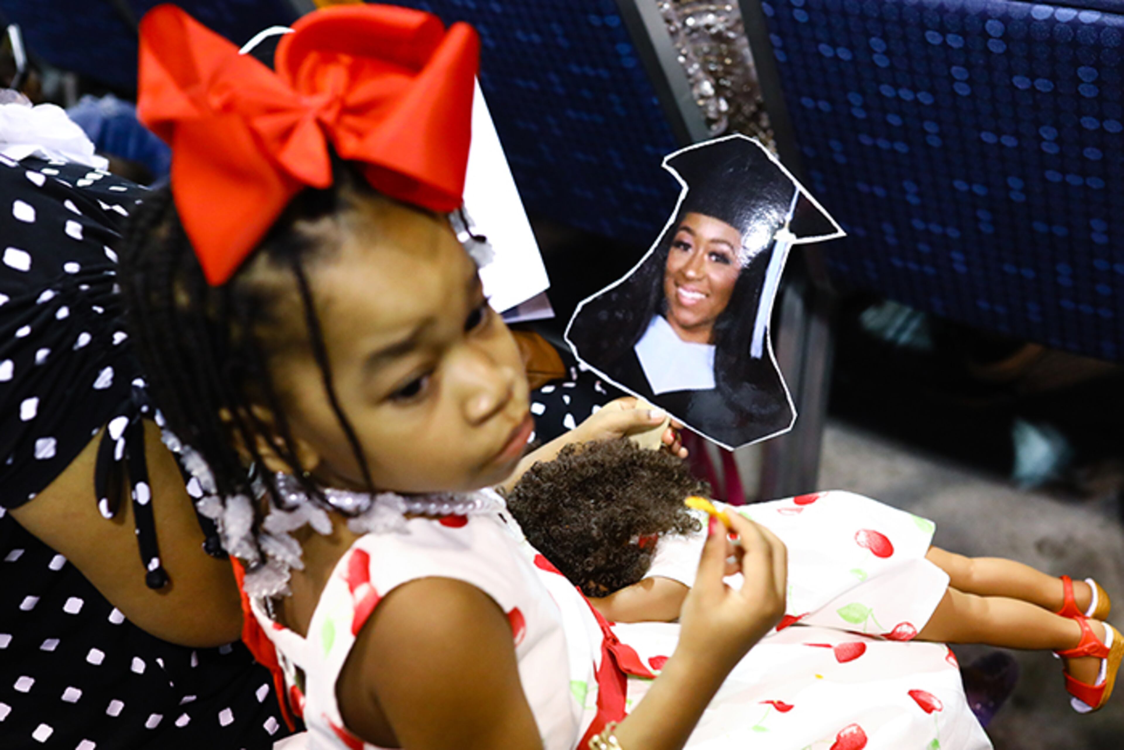 Raeghan Fisher, 5, holds her doll and a hand sign with the image of her sister Rakirah Fisher at the 132nd Spelman College commencement ceremony on Sunday, May 19, 2019, at the Georgia International Convention Center. (Photo: ELIJAH NOUVELAGE/SPECIAL TO THE AJC)
