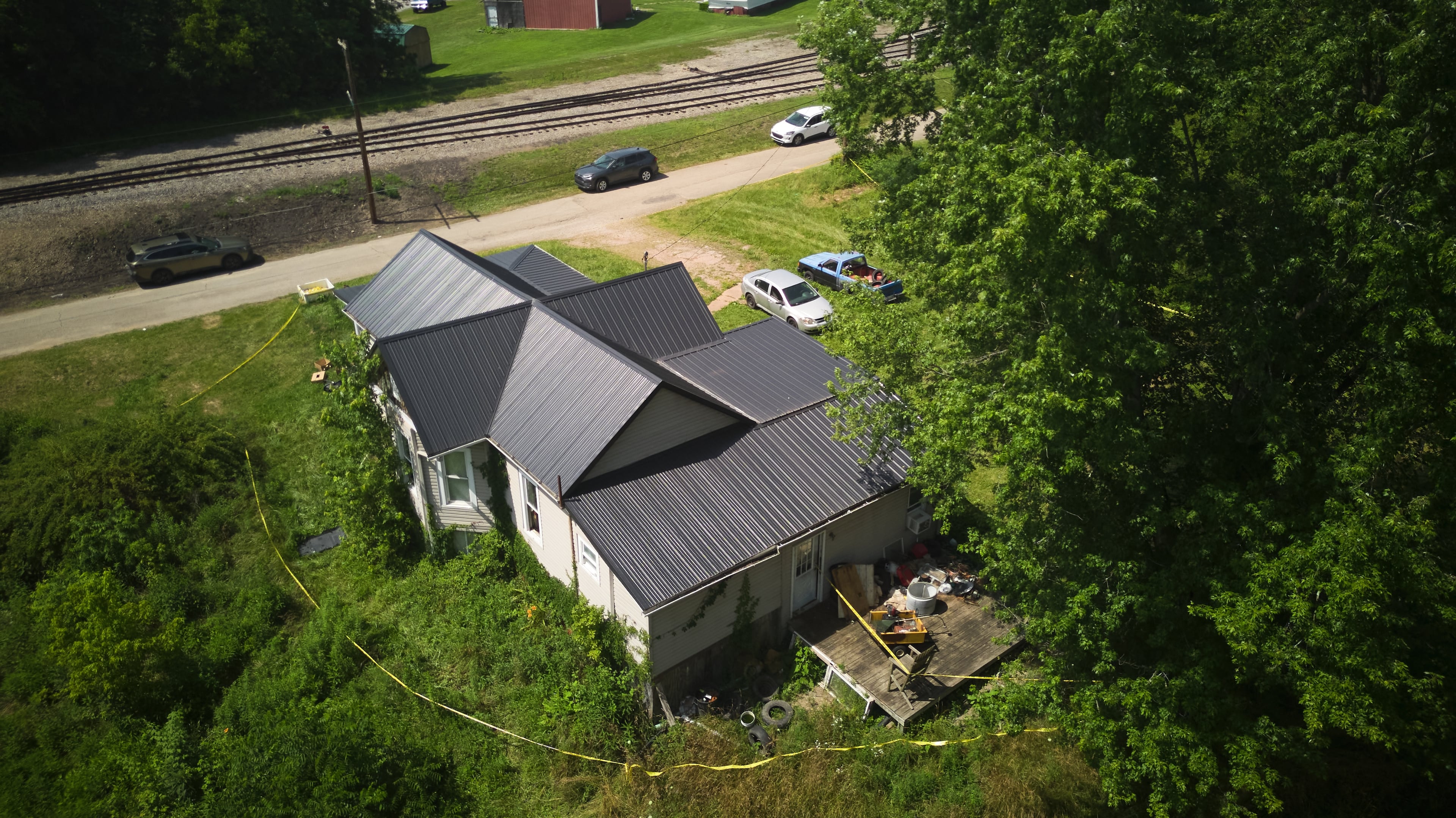Police tape surrounds a home where authorities say they removed 16 children and arrested four adults in Hamden, Ohio, Wednesday, July 1, 2026. (AP Photo/Carolyn Kaster)