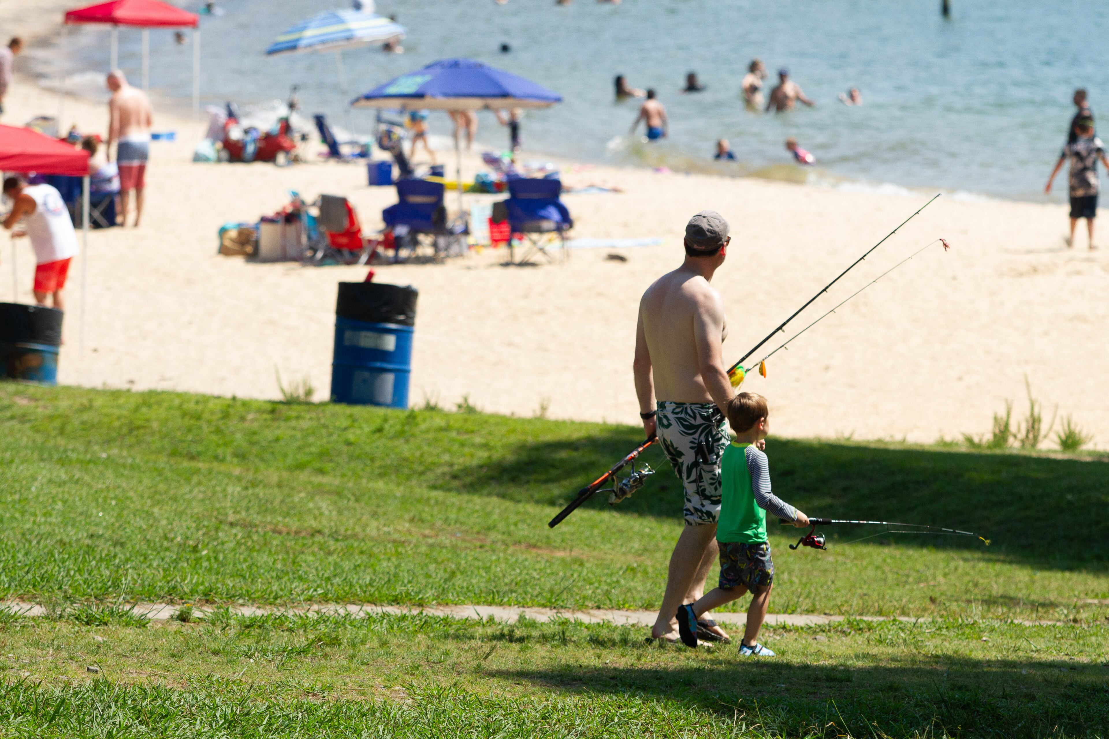 Josh Tomy and his son Jonah head for there fishing place at Mary Alice Beach Park in Lake Lanier on Sunday, July 5, 2020. STEVE SCHAEFER FOR THE ATLANTA JOURNAL-CONSTITUTION