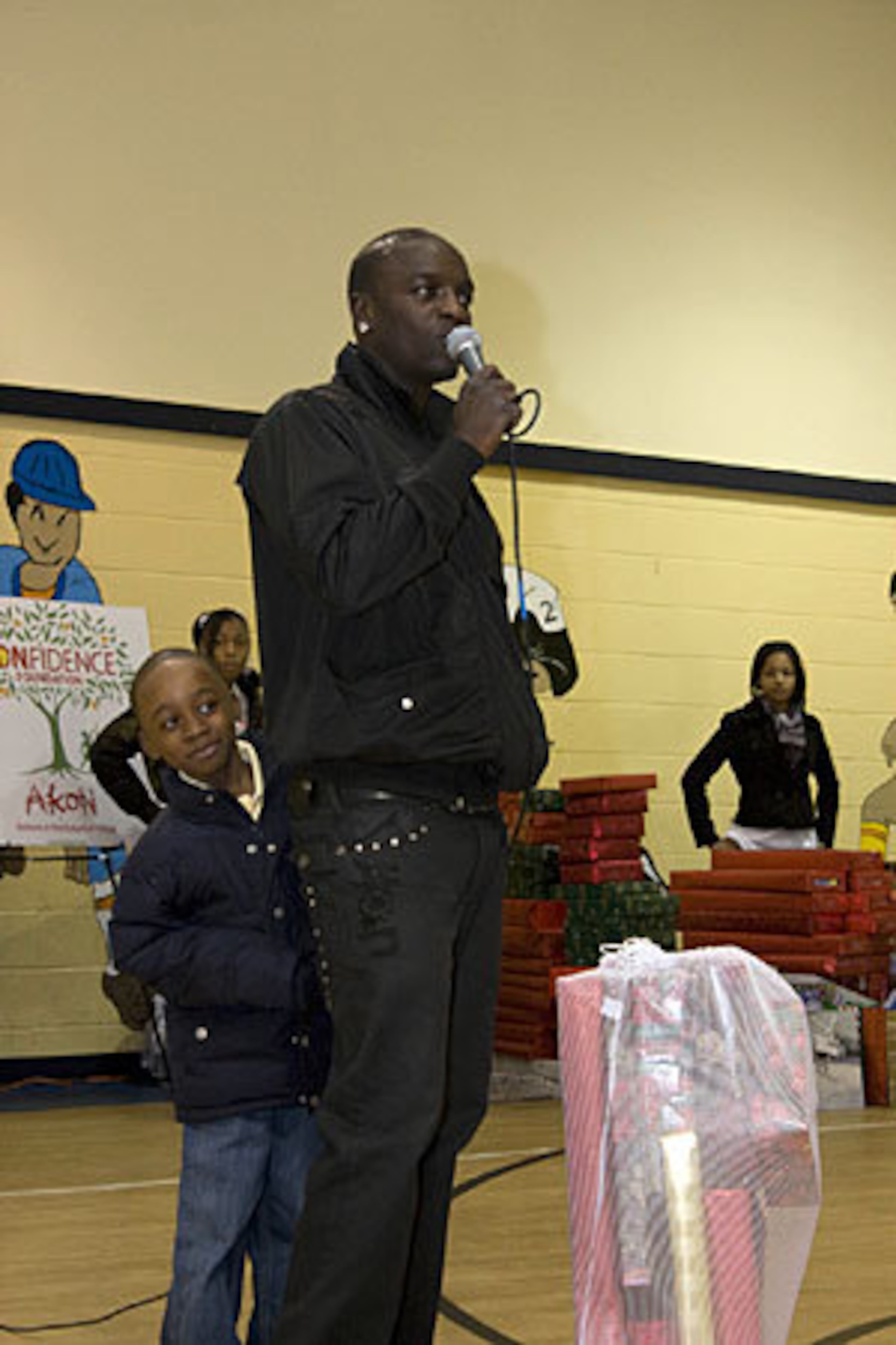 Akon gets an assist from one of the members of the Boys & Girls Clubs of Metro Atlanta. The singer visited two of the clubs on Tuesday afternoon: The John H. Harland Boys & Girls Club and the Joseph B. Whitehead Boys & Girls Club.