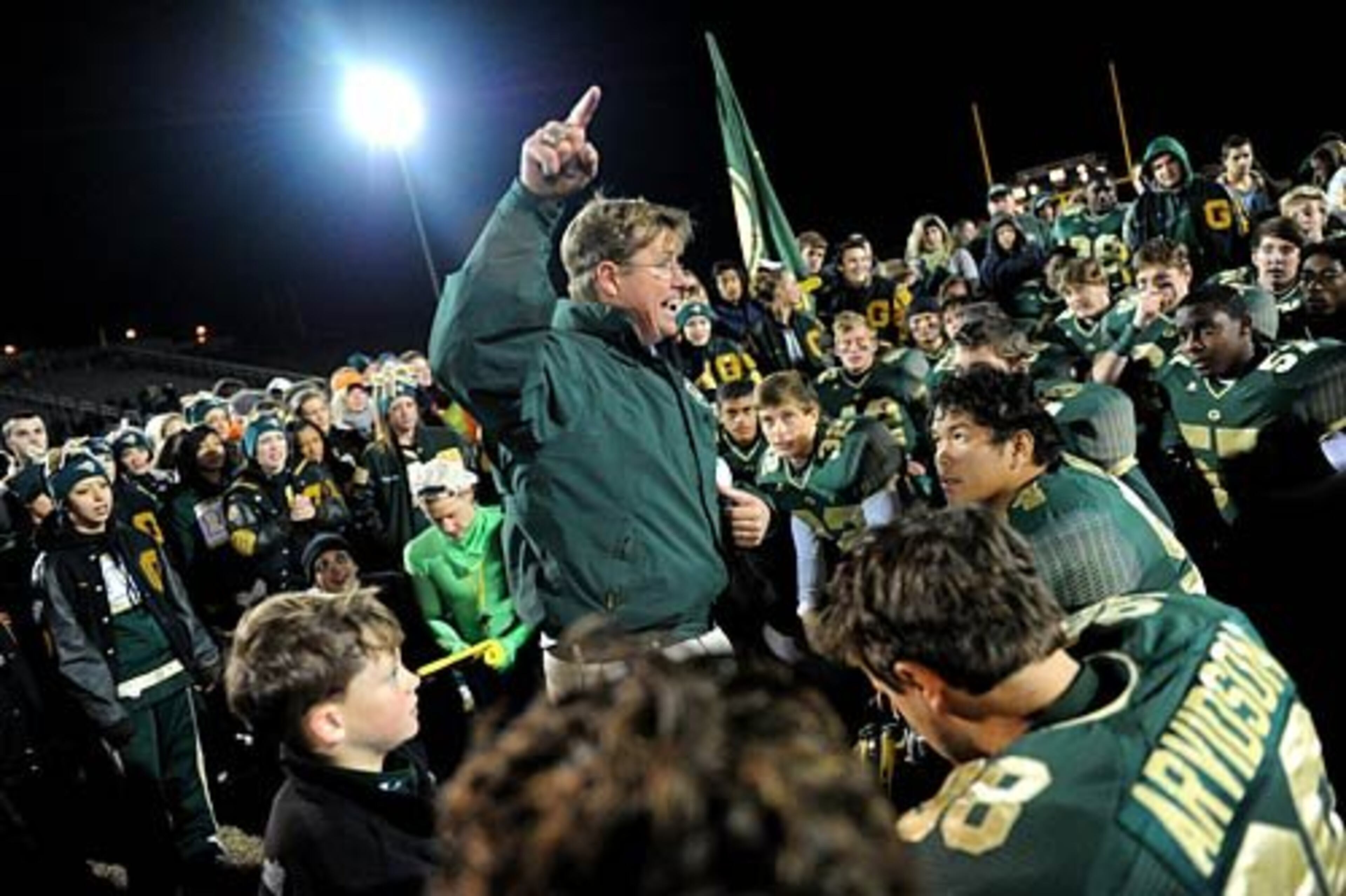 Surrounded by his players and fans, Grayson head coach Mickey Conn celebrates his team's 25-17 victory over Lowndes.
