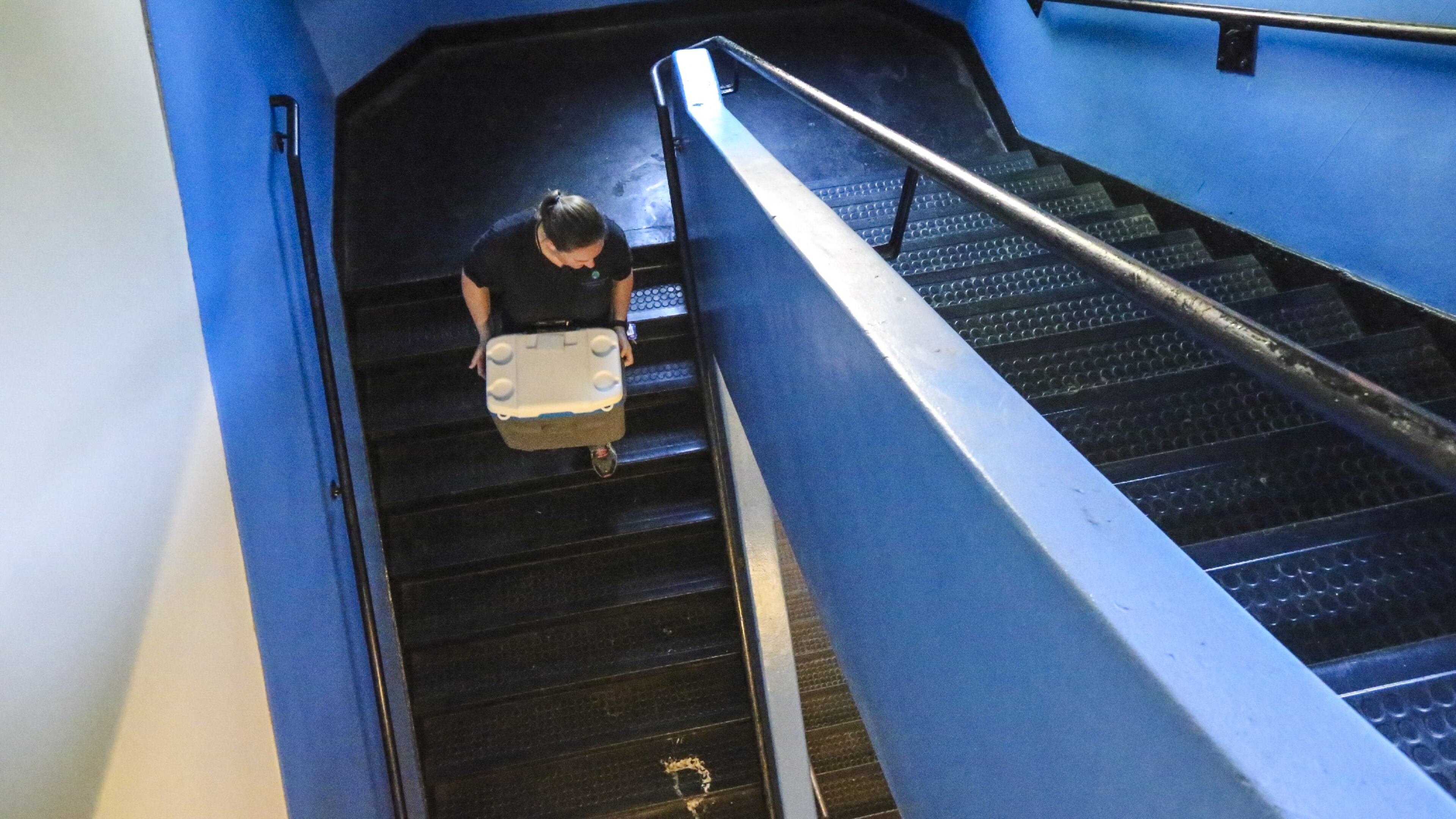 A Morley Environmental carries containers of water samples from faucets at the APS’ Capitol View building. JOHN SPINK /JSPINK@AJC.COM