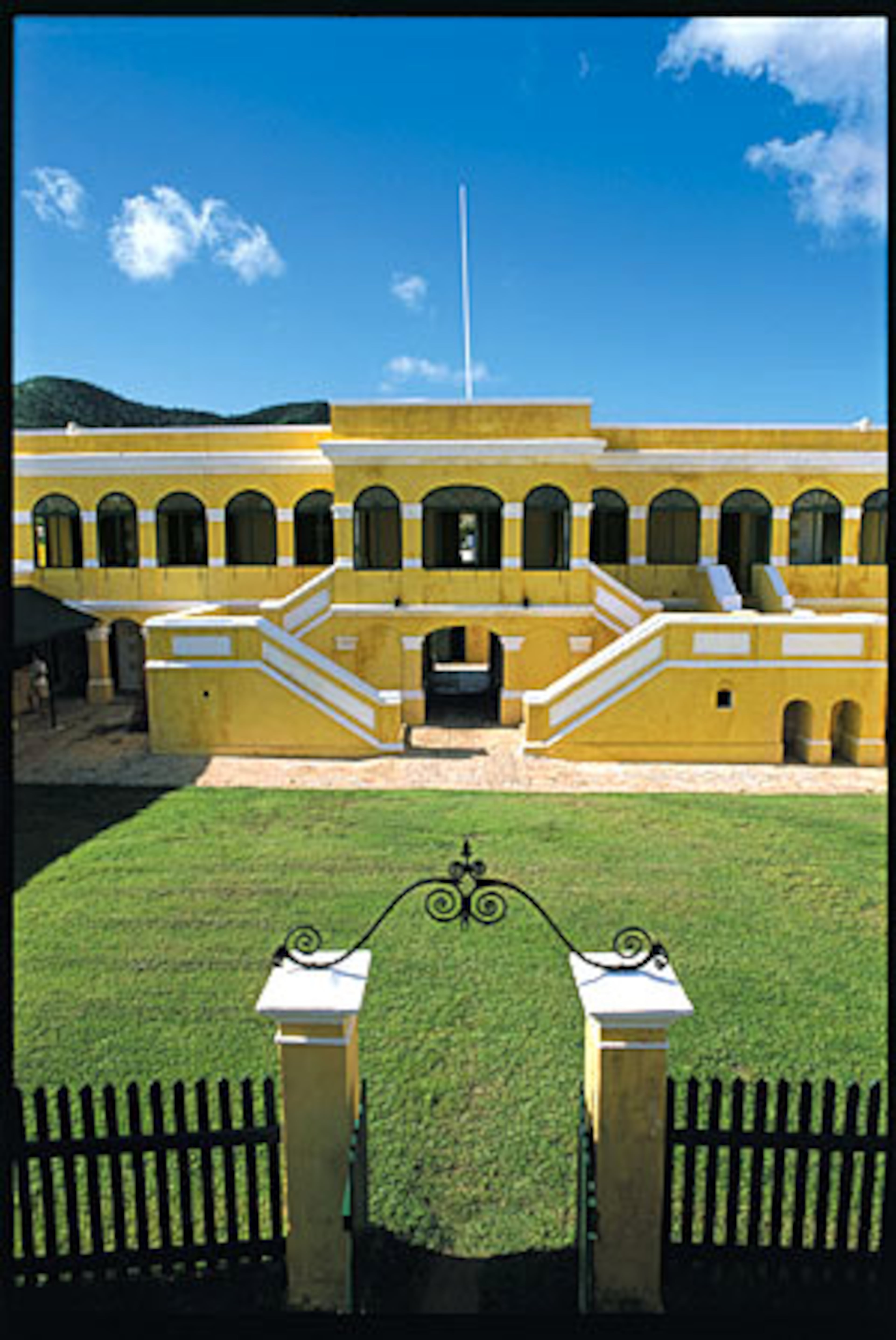 The bright yellow Fort Christiansvaern, with cannons trained on the harbor entrance, is part of the Christiansted National Historic Site on the Christiansted waterfront in St. Croix.