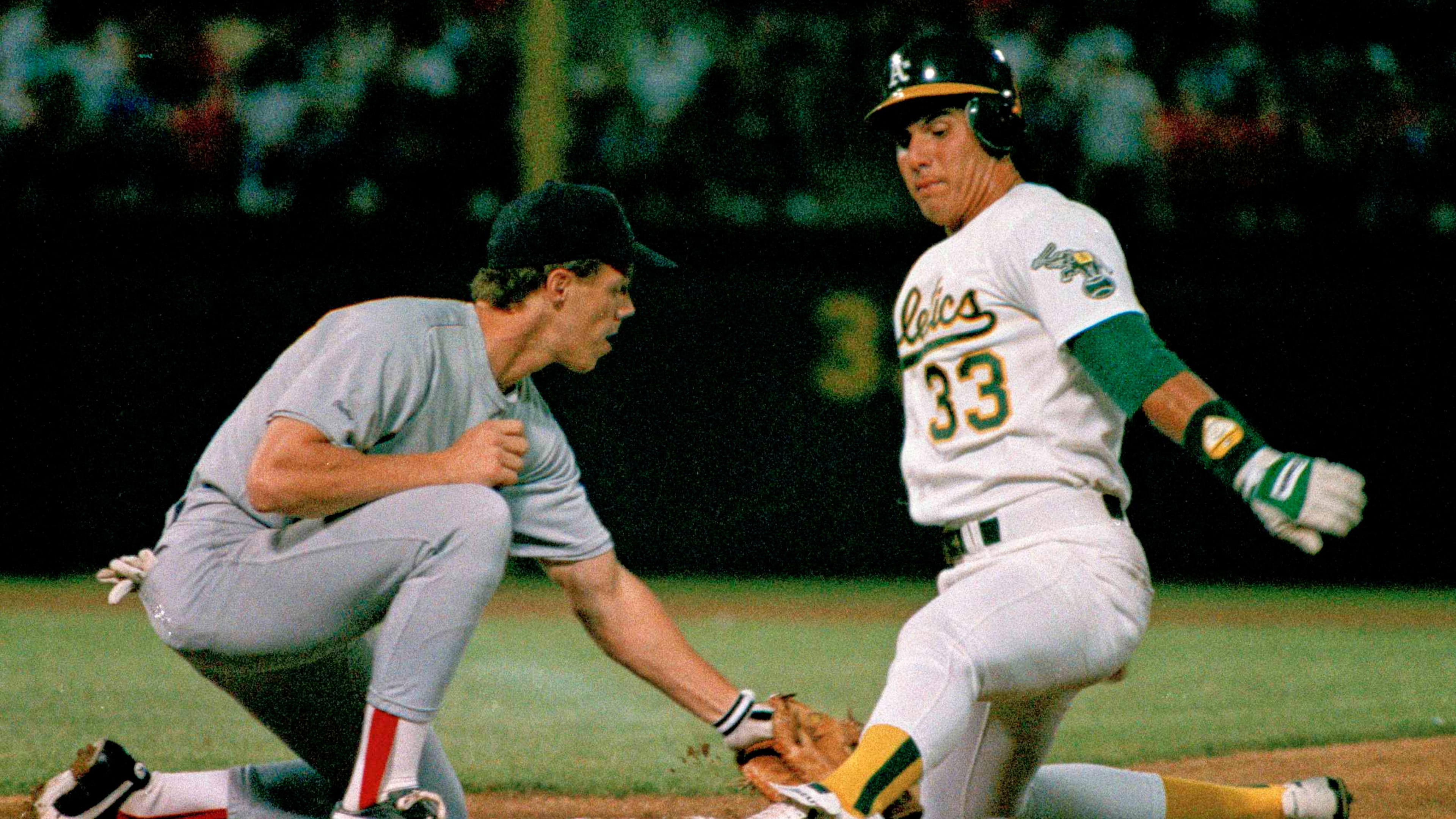 FILE - Oakland Athletics' Jose Canseco is almost off picked off by Boston Red Sox first baseman Todd Benzinger during the first inning of a baseball game, Monday, Aug. 29, 1988, in Oakland, Calif. (AP Photo/Paul Sakuma, File)
