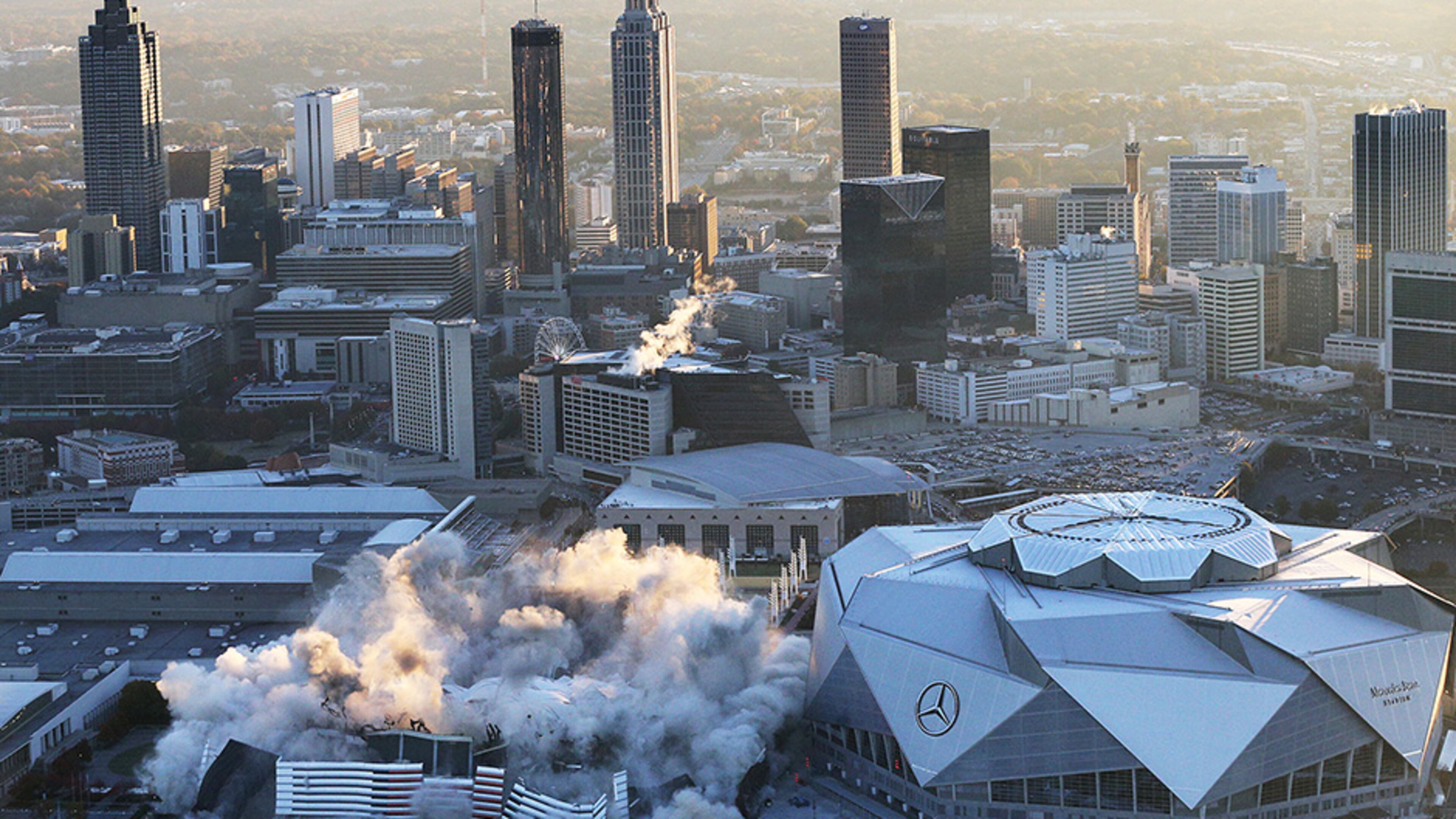 Mercedes-Benz Stadium, shown during the implosion of the Georgia Dome on Nov. 20, will host the College Football Playoff’s national championship game Jan. 8.