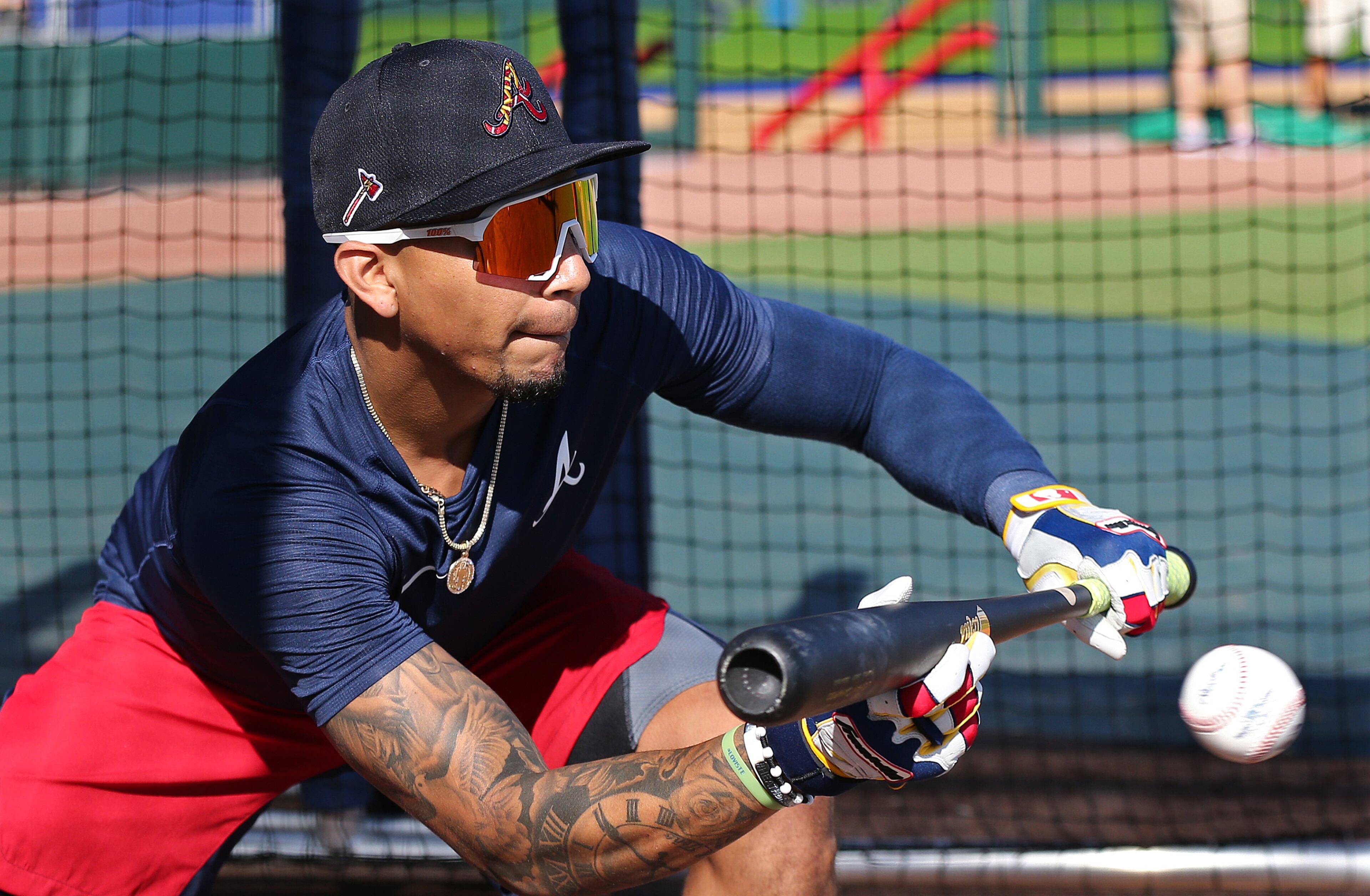 Braves infielder Johan Camargo lays down a bunt during batting practice in CoolToday Park during spring training on Saturday, Feb. 15, 2020, in North Port. Curtis Compton ccompton@ajc.com