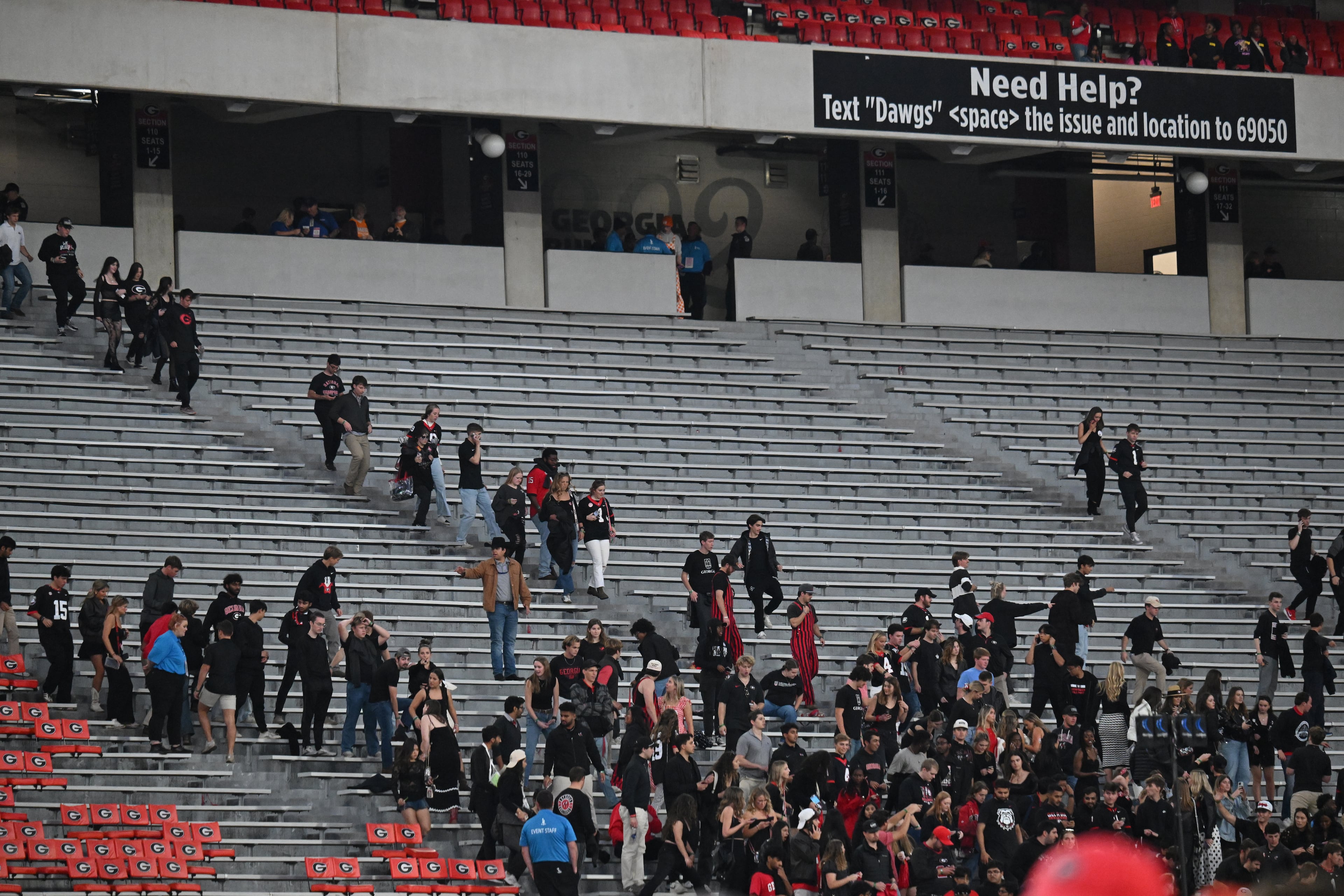 Georgia fans wearing black outfits rush to get their seats before an NCAA football game between Georgia and Tennessee at Sanford Stadium, Saturday, November 16, 2024, in Athens. (Hyosub Shin / AJC)