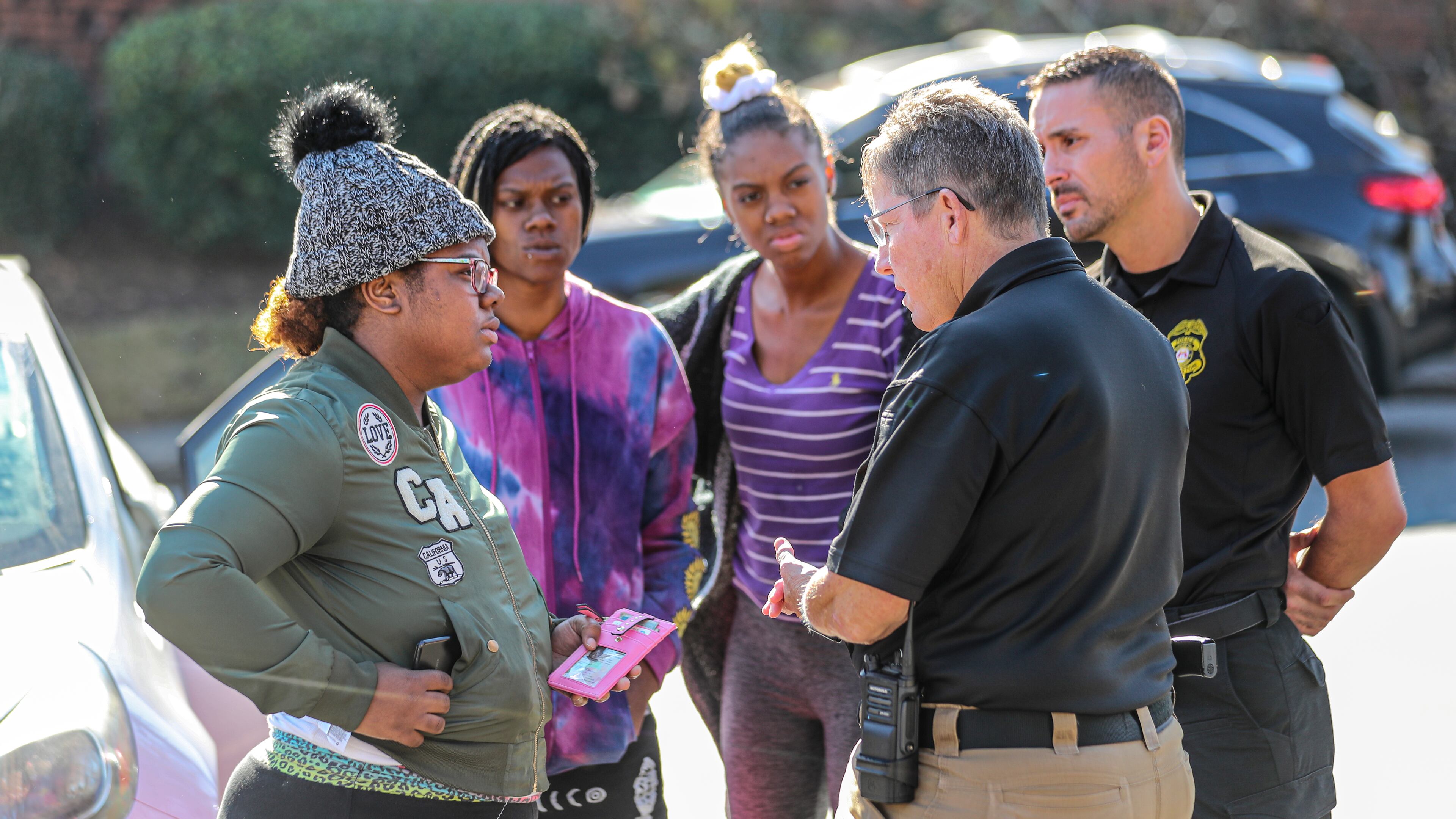 Deonna Bray (left) speaks with Clarkston police Chief Christine Hudson (second from right) during the search for Bray's missing 1-year old, Blaise Barnett. It's been one week since the mother and child were reunited, and Clarkston police said they have not identified any suspects.