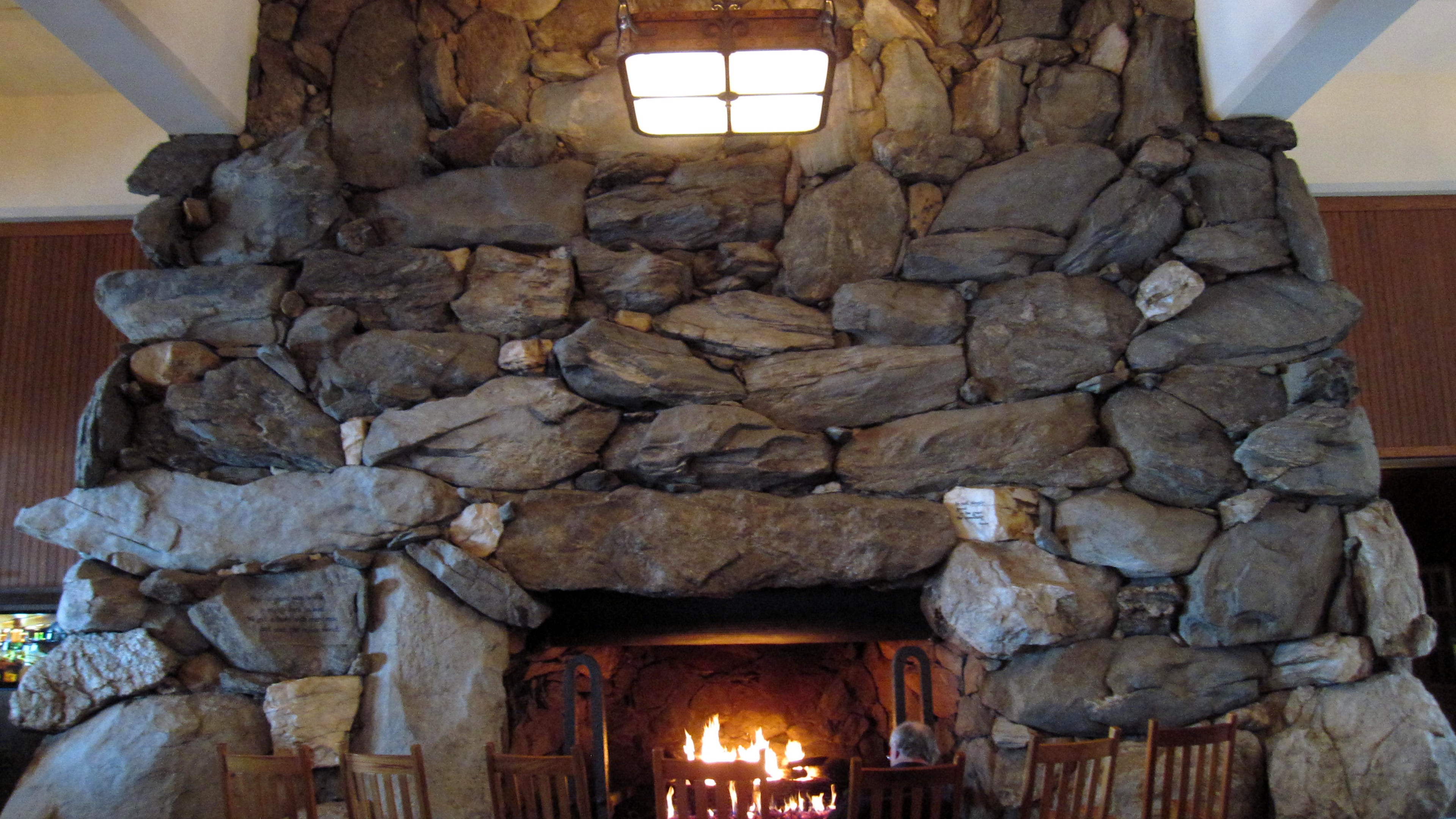 FILE - This Feb. 2, 2015 photo shows rocking chairs in front of the massive stone fireplace in the lobby of the Grove Park Inn in Asheville, N.C. (AP Photo/Beth J. Harpaz, File)