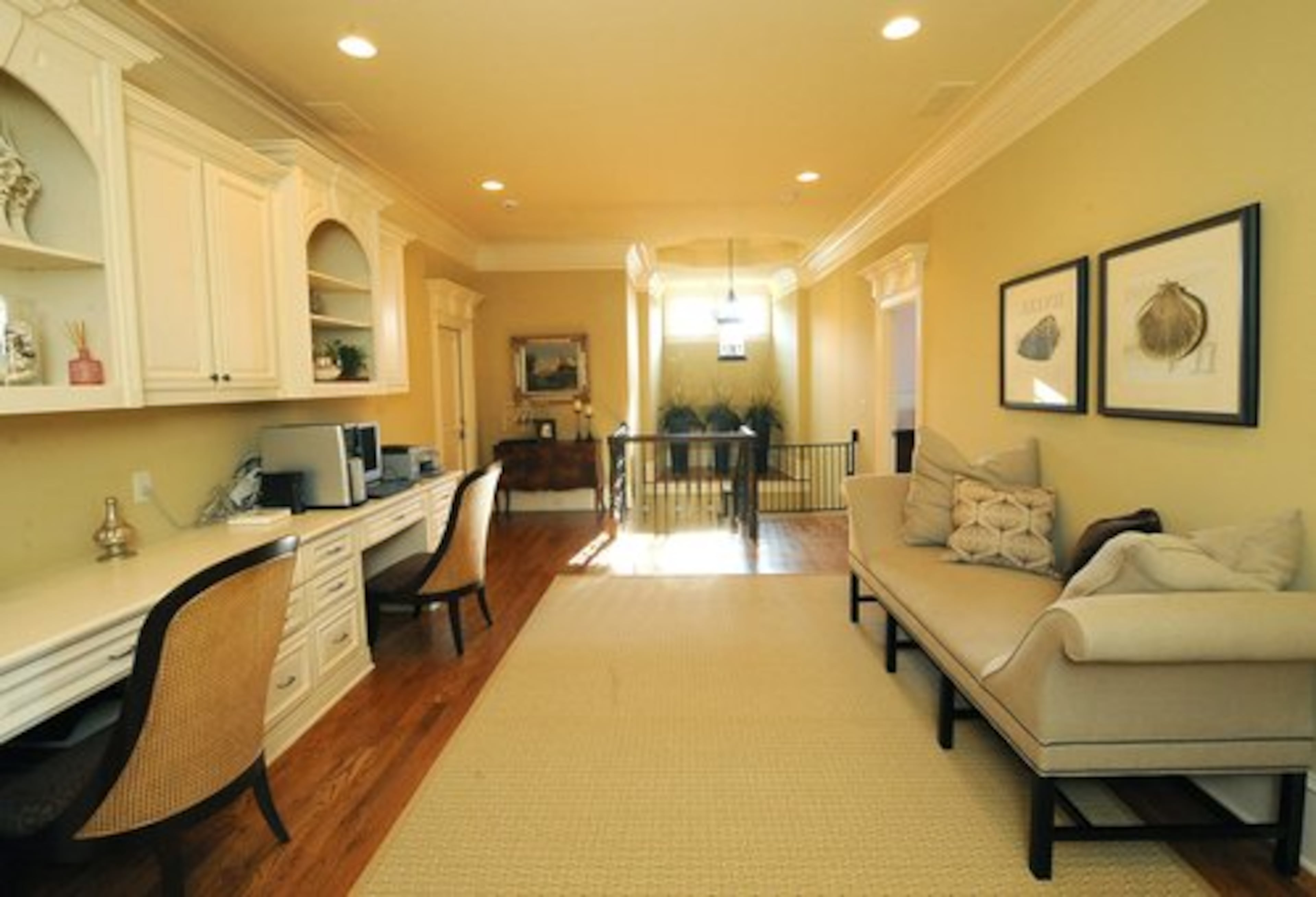 The upstairs hallway serves as an open office and loft area. Hints of a beach theme harken to the Slocums' former home in Pensacola.