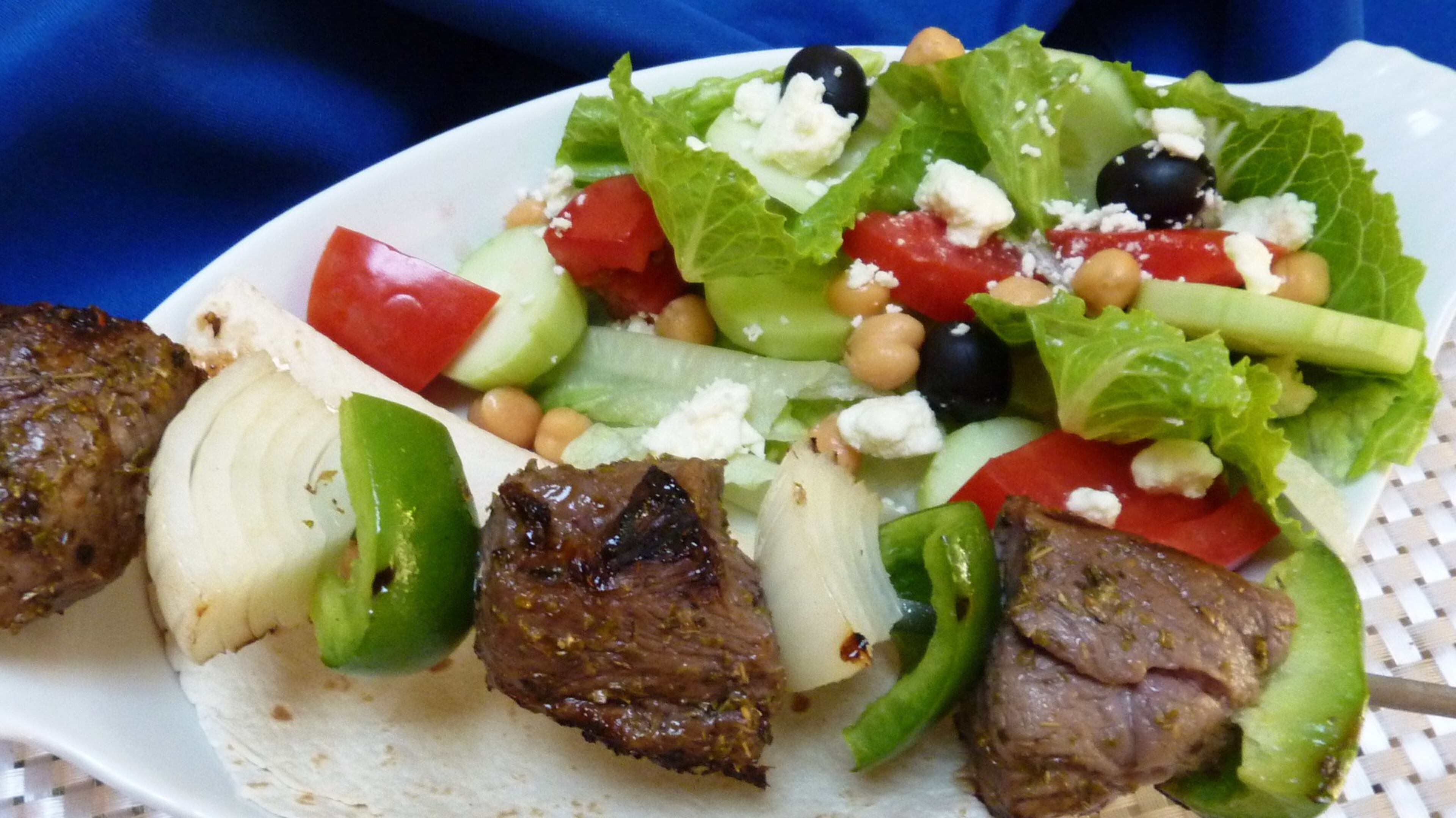 Flavorful lamb kebobs paired with a hearty salad is a great, summery meal. (Linda Gassenheimer/TNS)