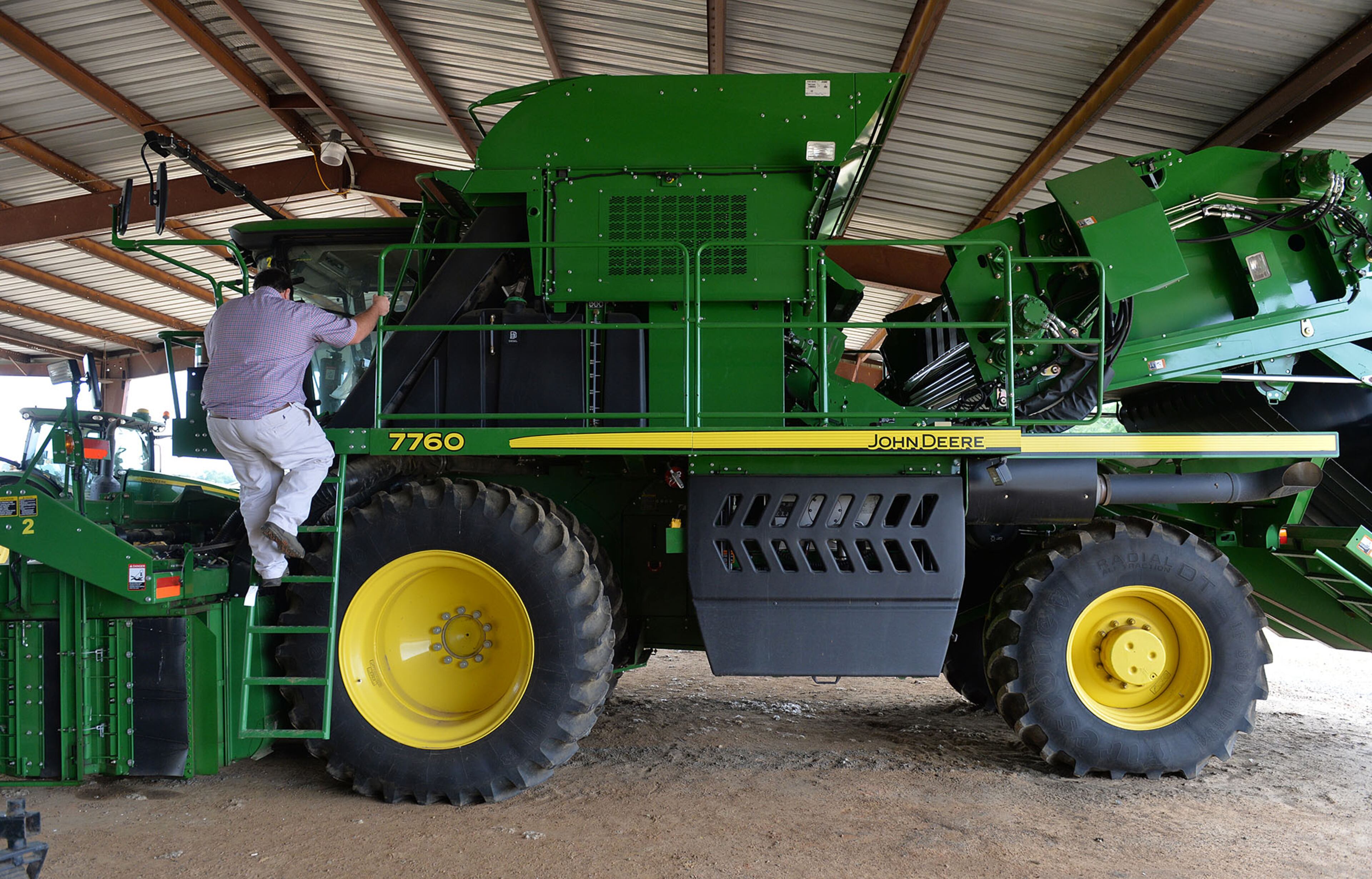 Matt Coley climbs aboard his John Deere cotton picker on June 10, 2015. The machine, with a price tag of around $700,000 is the heart of the family farm.