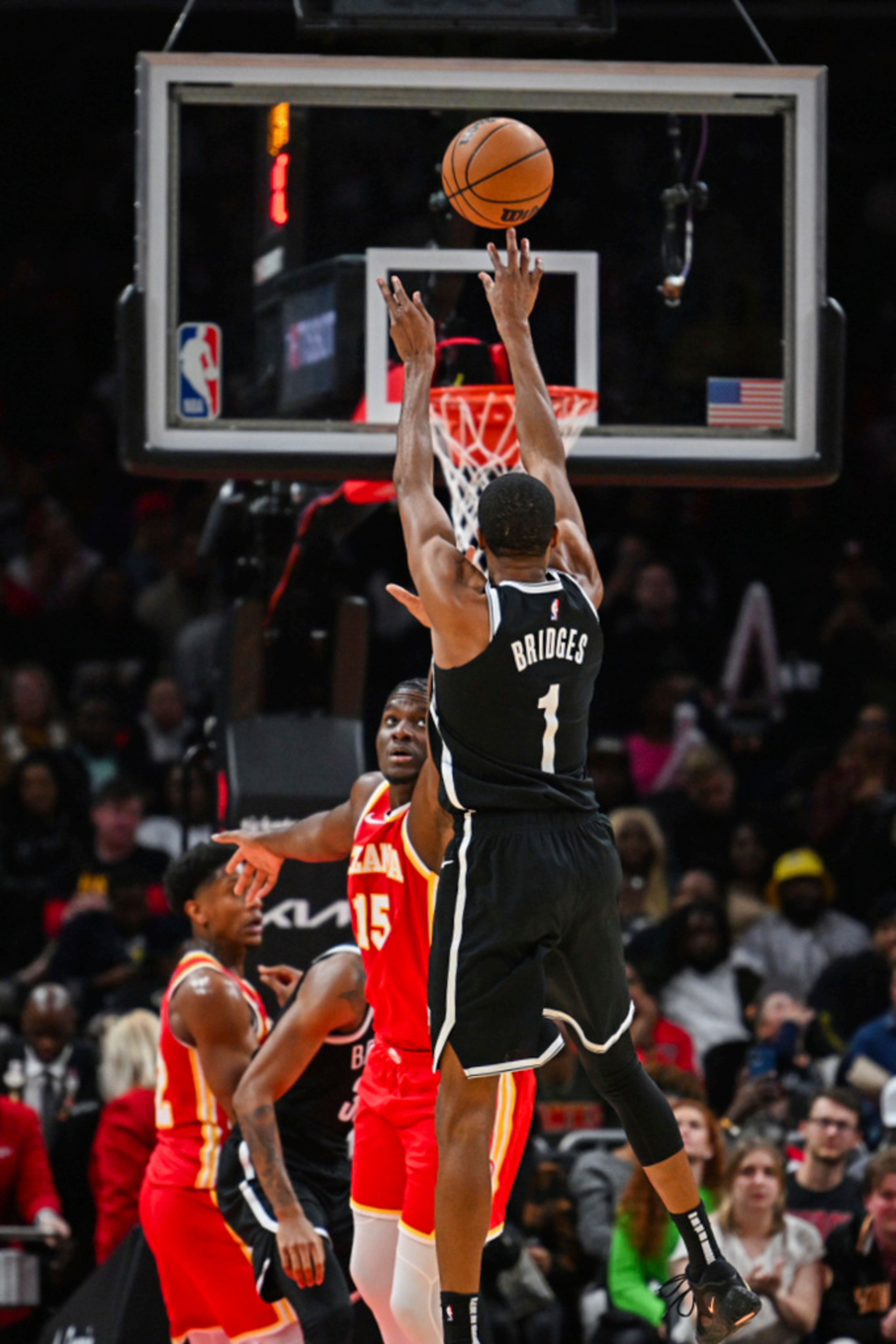 Brooklyn Nets forward Mikal Bridges (1) shoots a 3-pointer against Atlanta Hawks center Clint Capela (15) during the second half of an NBA basketball game Wednesday, Dec. 6, 2023, in Atlanta. (AP Photo/Hakim Wright Sr.)