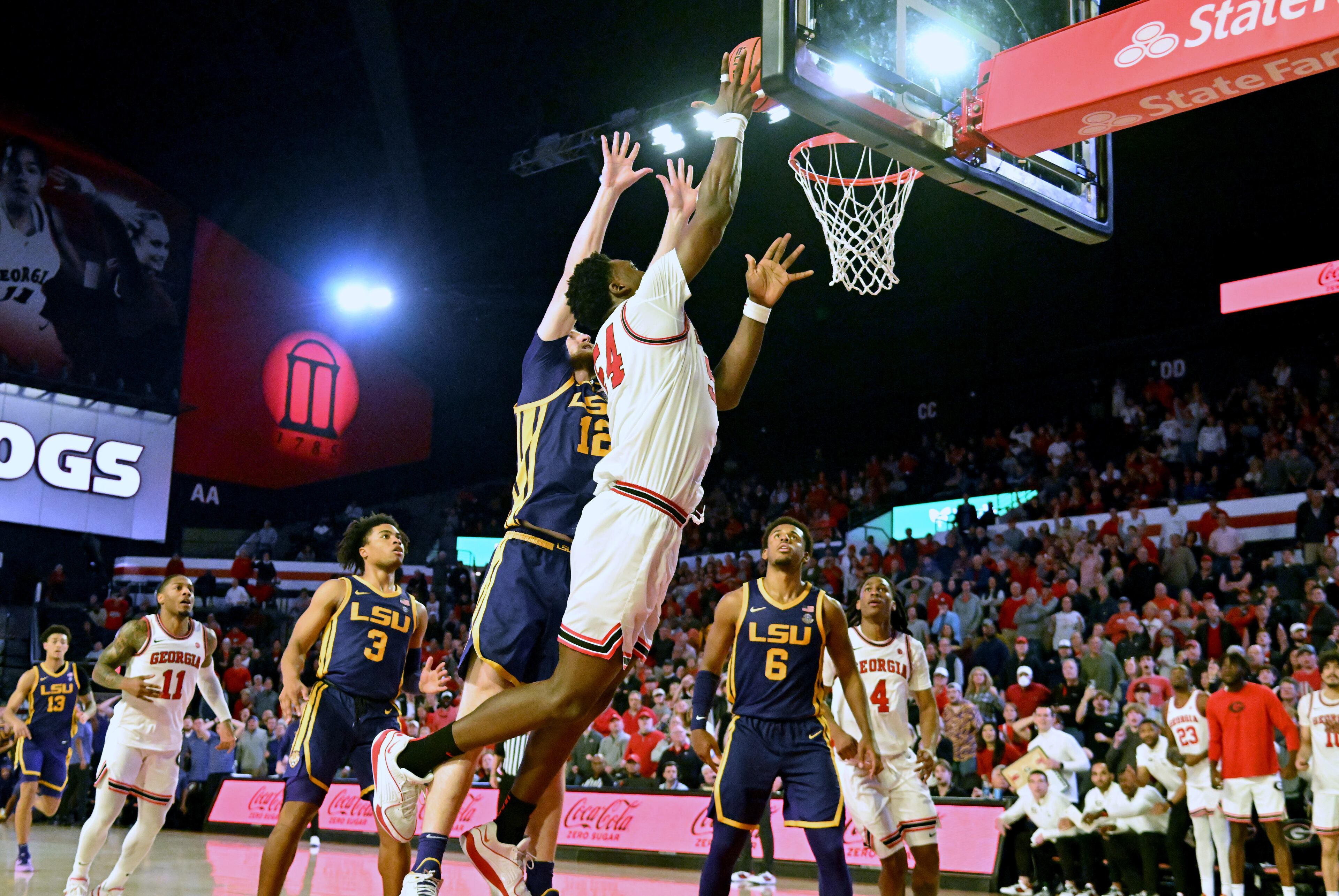 Georgia center Russel Tchewa (54) goes to the basket past LSU forward Hunter Dean (12) for the game-winning shot at the end of the second half of an NCAA college basketball game at Stegeman Coliseum, Wednesday, January 24, 2024, in Athens. Georgia won 68-66 over LSU. (Hyosub Shin / Hyosub.Shin@ajc.com)