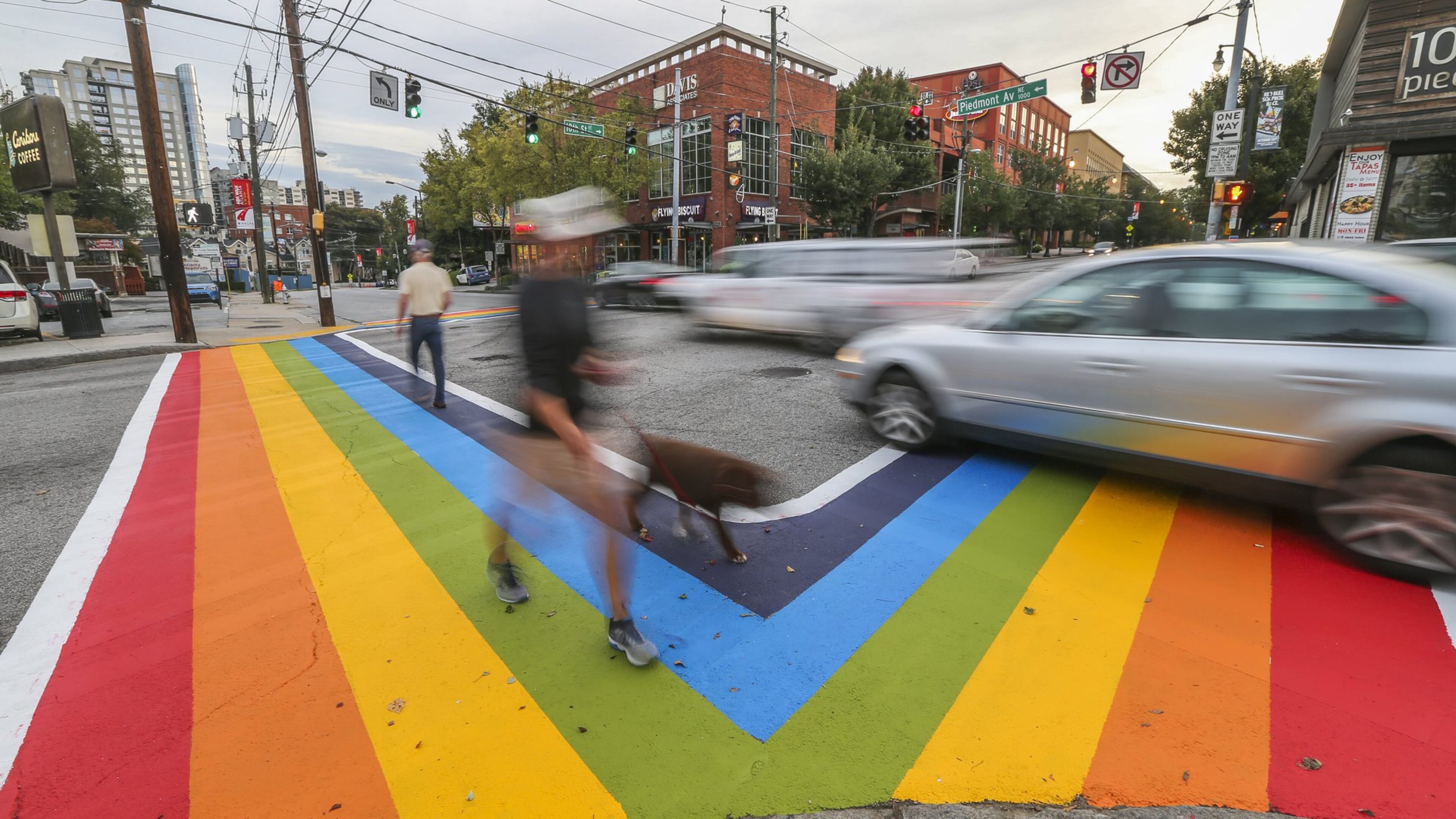 October 9, 2015 Atlanta: Motorists and pedestrians had a brand new perspective of 10th and Piedmont Avenue on Friday morning, Oct. 9, 2015 as the project to paint rainbow crosswalks in Midtown for the launch of Atlanta Pride that began late Thursday was completed. The colors won’t last forever. The city, citing safety concerns and state regulations, said the design cannot be permanent. It’s a decision that Robert Sepulveda, president of the Atlanta Rainbow Crosswalks, and other organizers want reversed. Sepulveda, whose organization uses public art to promote diversity, contends Mayor Kasim Reed’s office reneged on an initial pledge to allow the design for Atlanta Pride weekend to be permanent. “They told us it would be a permanent installation to the city of Atlanta’s art collection,” Sepulveda told Channel 2 Action News. “Midtown is the epicenter for the LGBT community so it just makes sense.” JOHN SPINK /JSPINK@AJC.COM