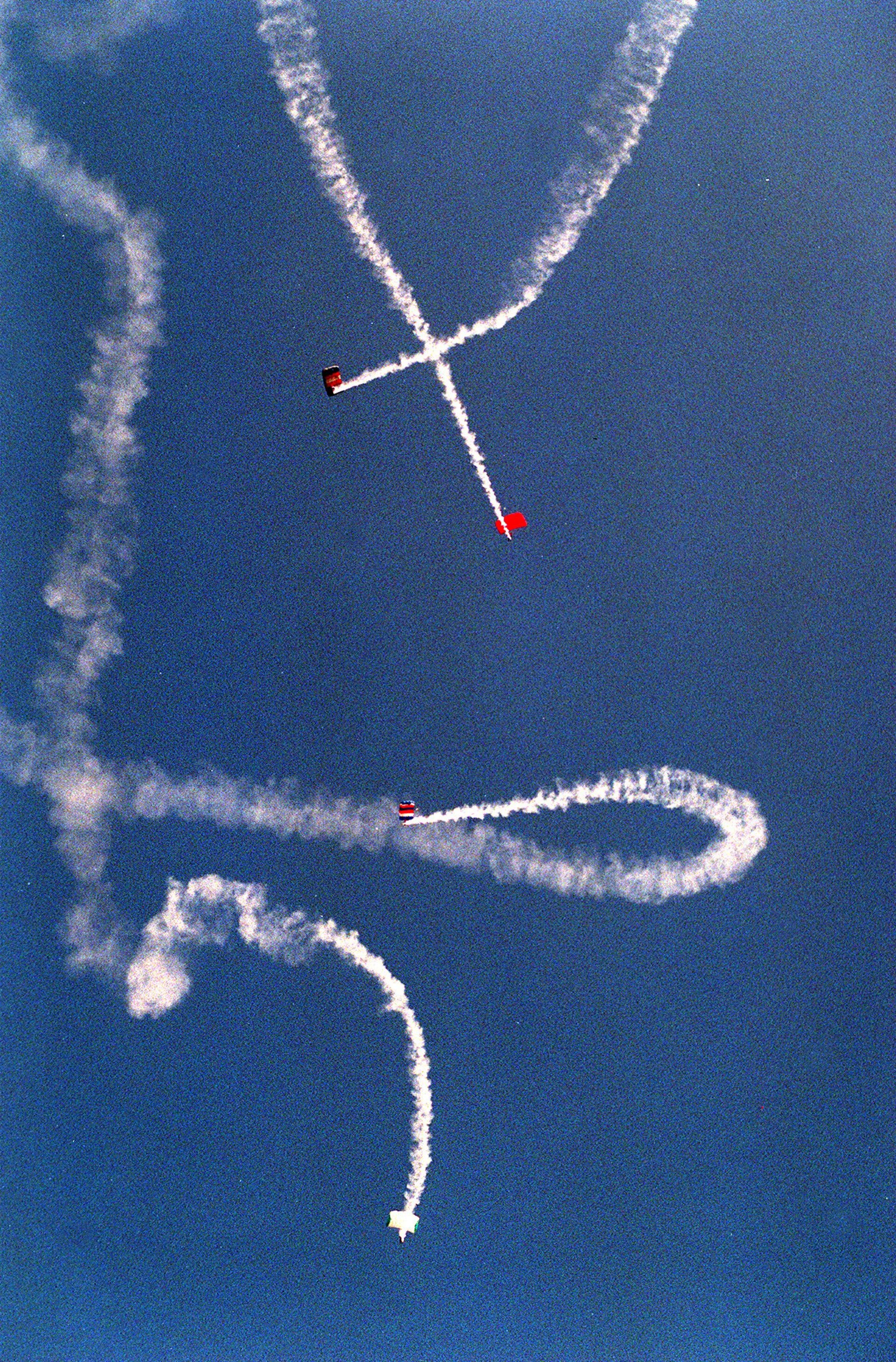 Skydivers kick off the start the 4th of July parade in downtown Woodstock on Saturday in 1998. A parade was also held later in the day in Canton and in Holly Springs, with fireworks celebrations lighting up the evening sky at Hobgood Park, in downtown Woodstock, and at the RiverStone Plaza in Canton.