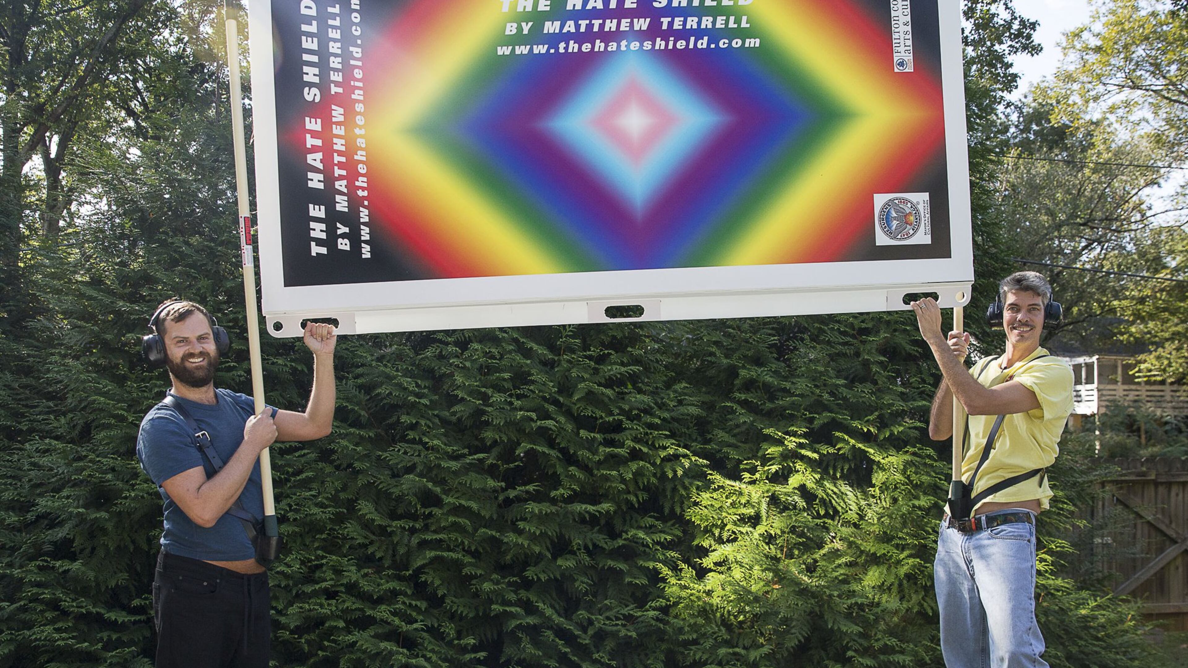 Visual artist Matthew Terrell (left) and fabricator George Faughnan (right) show off their latest project, The Hate Shield, at a residence in Atlanta, Wednesday, October 9, 2019. The walls are designed to be wielded up through harnesses and poles to block tall hateful signs. (Alyssa Pointer/alyssa.pointer@ajc.com)