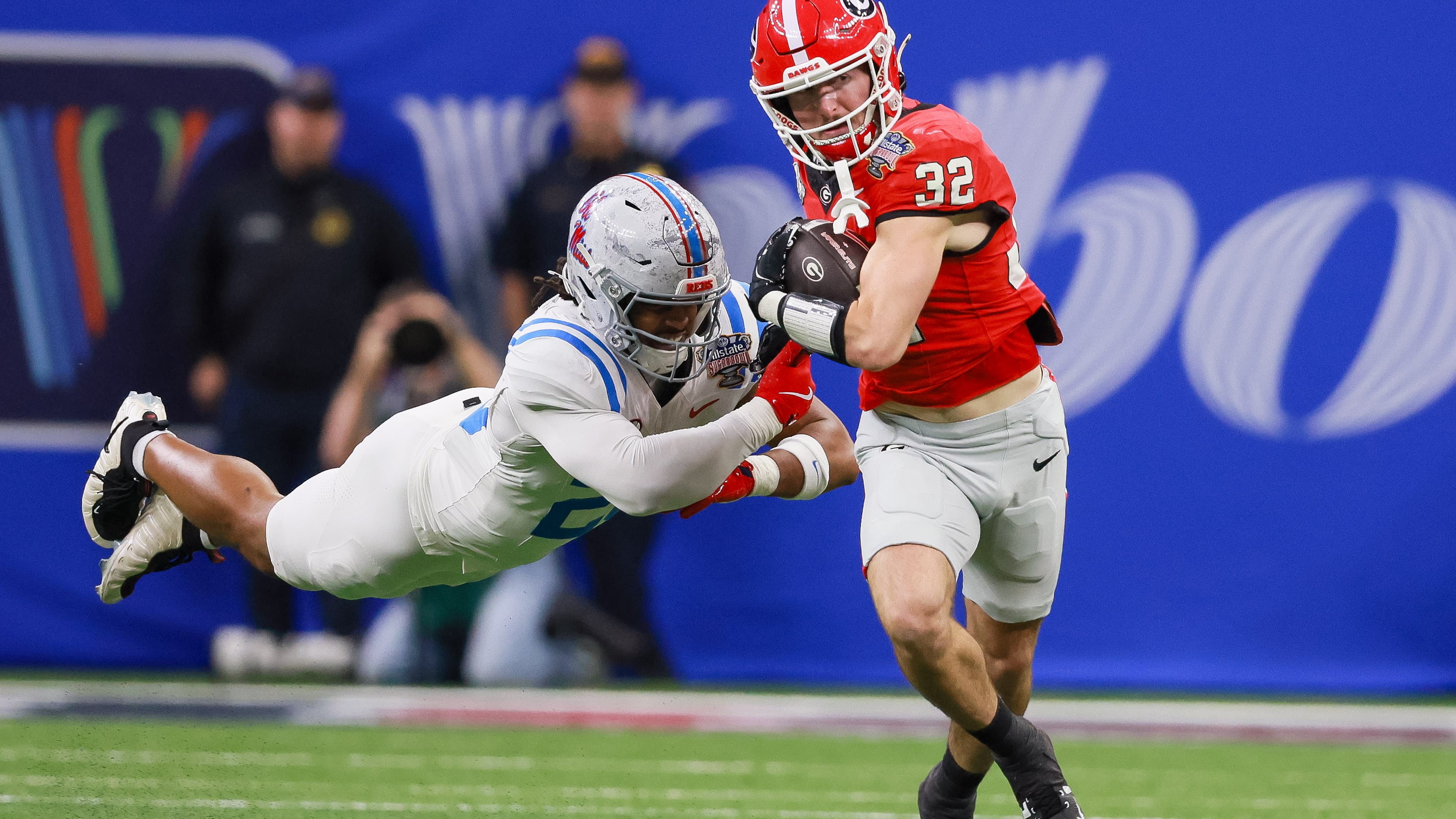 Georgia running back Cash Jones (right) — pictured running for a first down against Ole Miss in the College Football Playoff in January — did a little bit of everything for the Bulldogs after beginning his UGA career as a walk-on. (Jason Getz/AJC)