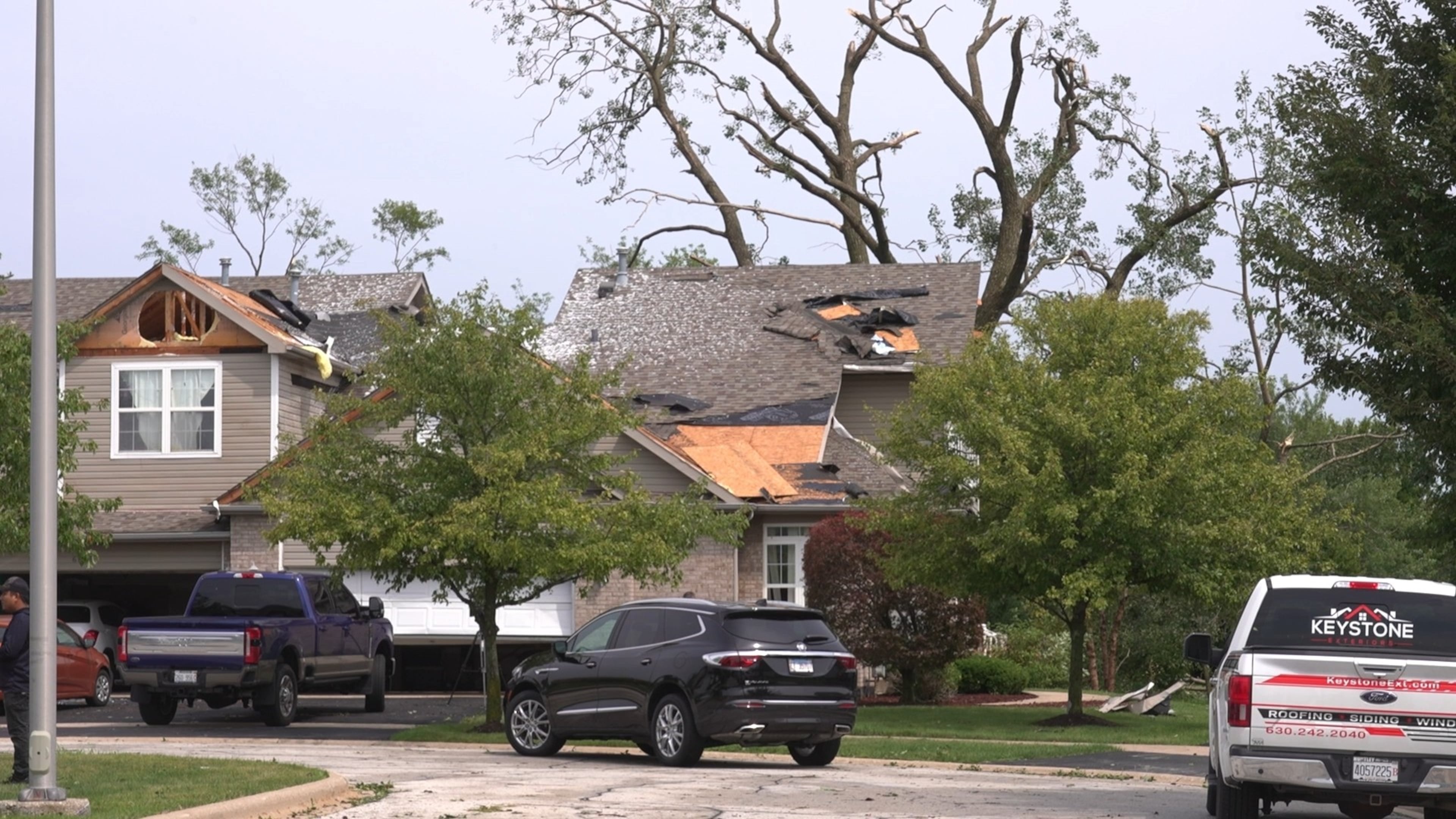 In this image made from video, a roof is damaged after a strong storm in Tinley Park, Ill., Tuesday, Aug. 11, 2026. (AP Photo/Laura Bargfeld)