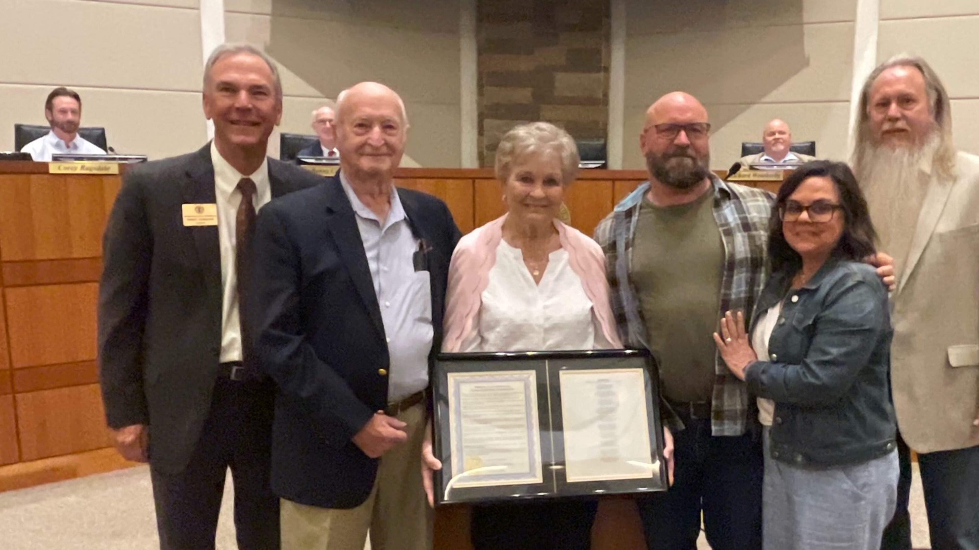 At an April Cherokee County Board of Commissioners meeting, a proclamation was presented to Kurt Wheeler and his mother Barbara for writing Cherokee County's song. From left are Chairman Harry Johnston, Gene Wheeler (Kurt’s father), Barbara Wheeler (Kurt’s mother), Kurt Wheeler, Janet Wheeler (Kurt’s wife) and District 1 Commissioner Steve West. (Courtesy of Cherokee County)