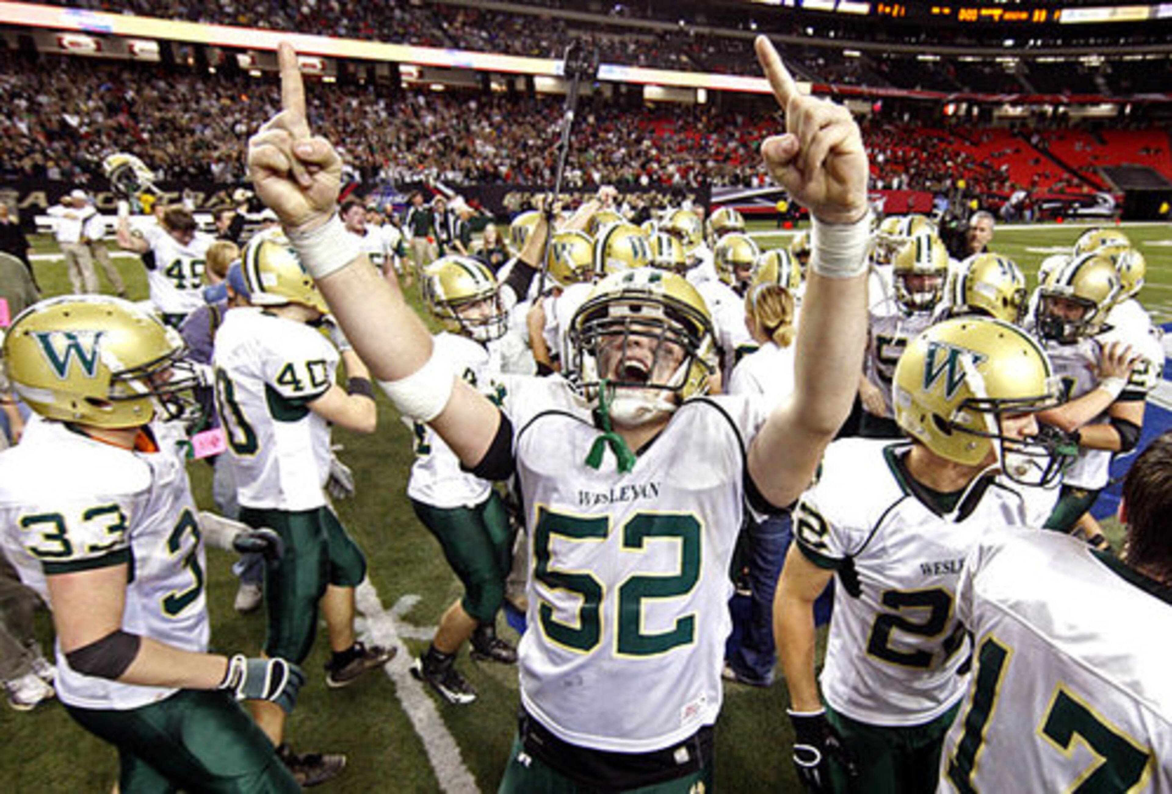 Wesleyan's Brady Donovan (52) celebrates as time expires Wesleyan's 33-21.