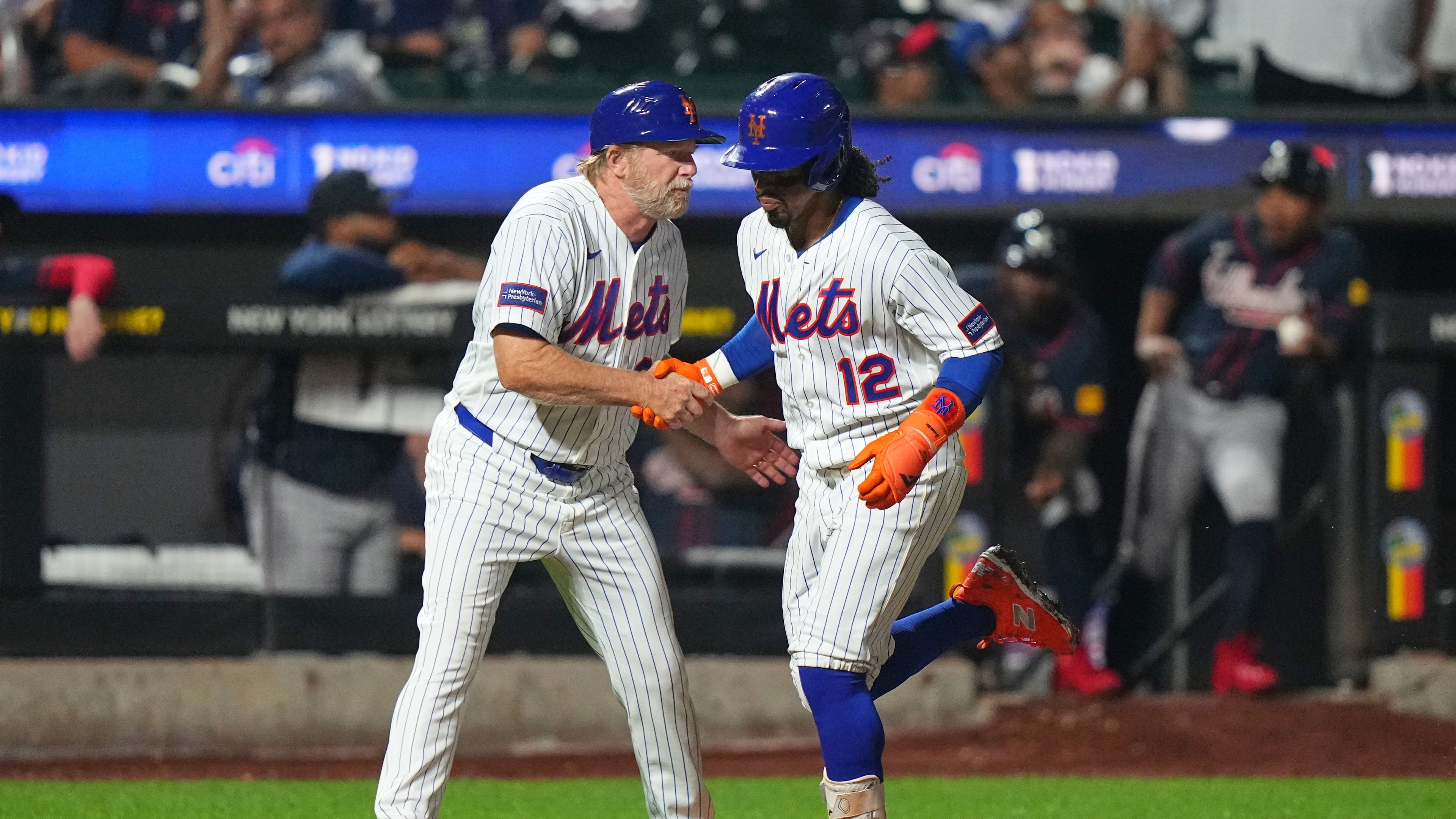 New York Mets third base coach Tim Leiper, left, celebrates with Francisco Lindor as he runs the bases after hitting a three-run home run during the eighth inning of a baseball game against the Atlanta Braves Monday, July 27, 2026, in New York. (AP Photo/Frank Franklin II)