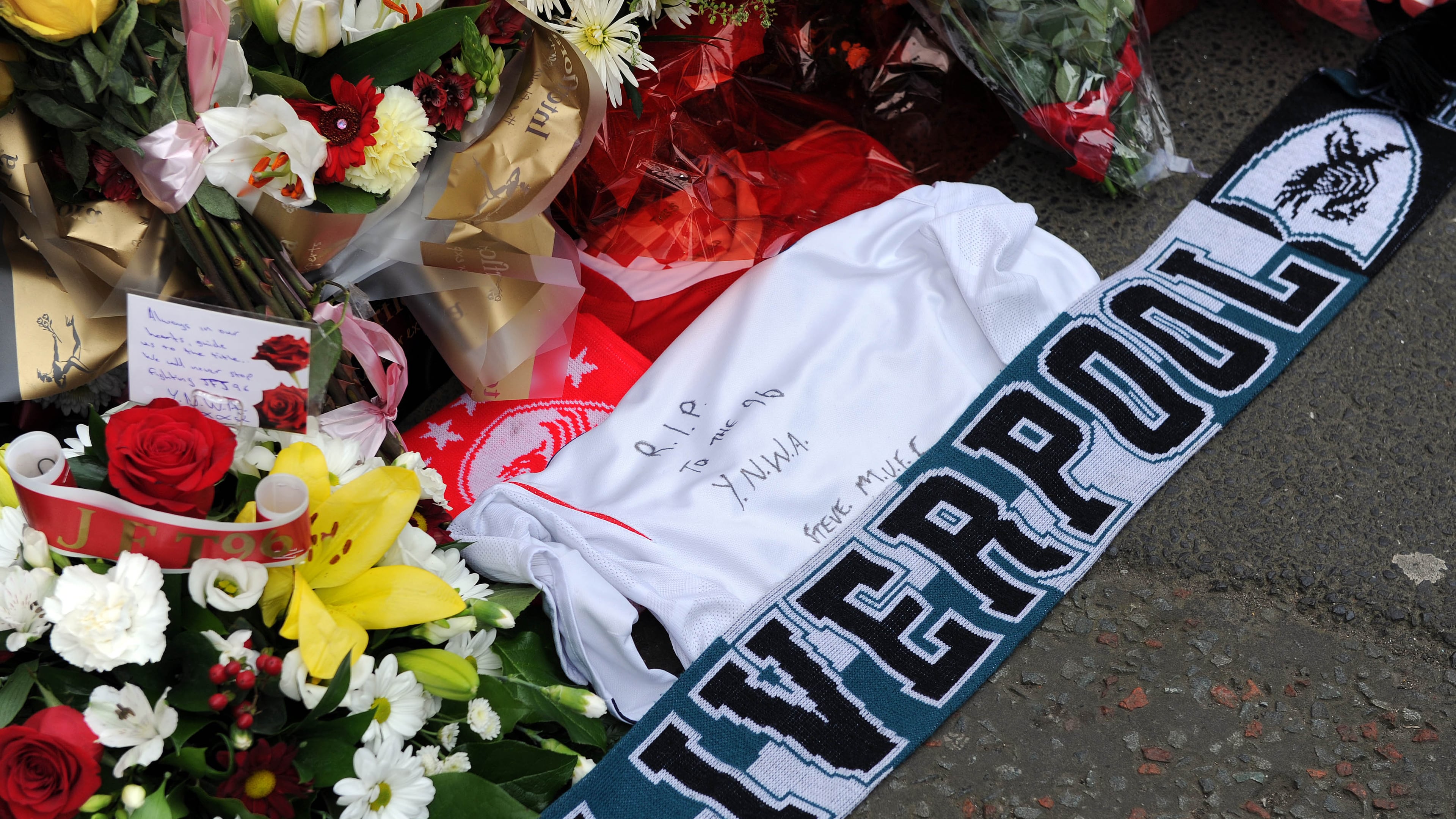 FILE -Tributes are laid at the memorial of the Hillsborough disaster outside Anfield before the English Premier League soccer match between Liverpool and Manchester City at Anfield in Liverpool, England, April. 13, 2014. (AP Photo/Clint Hughes, File)