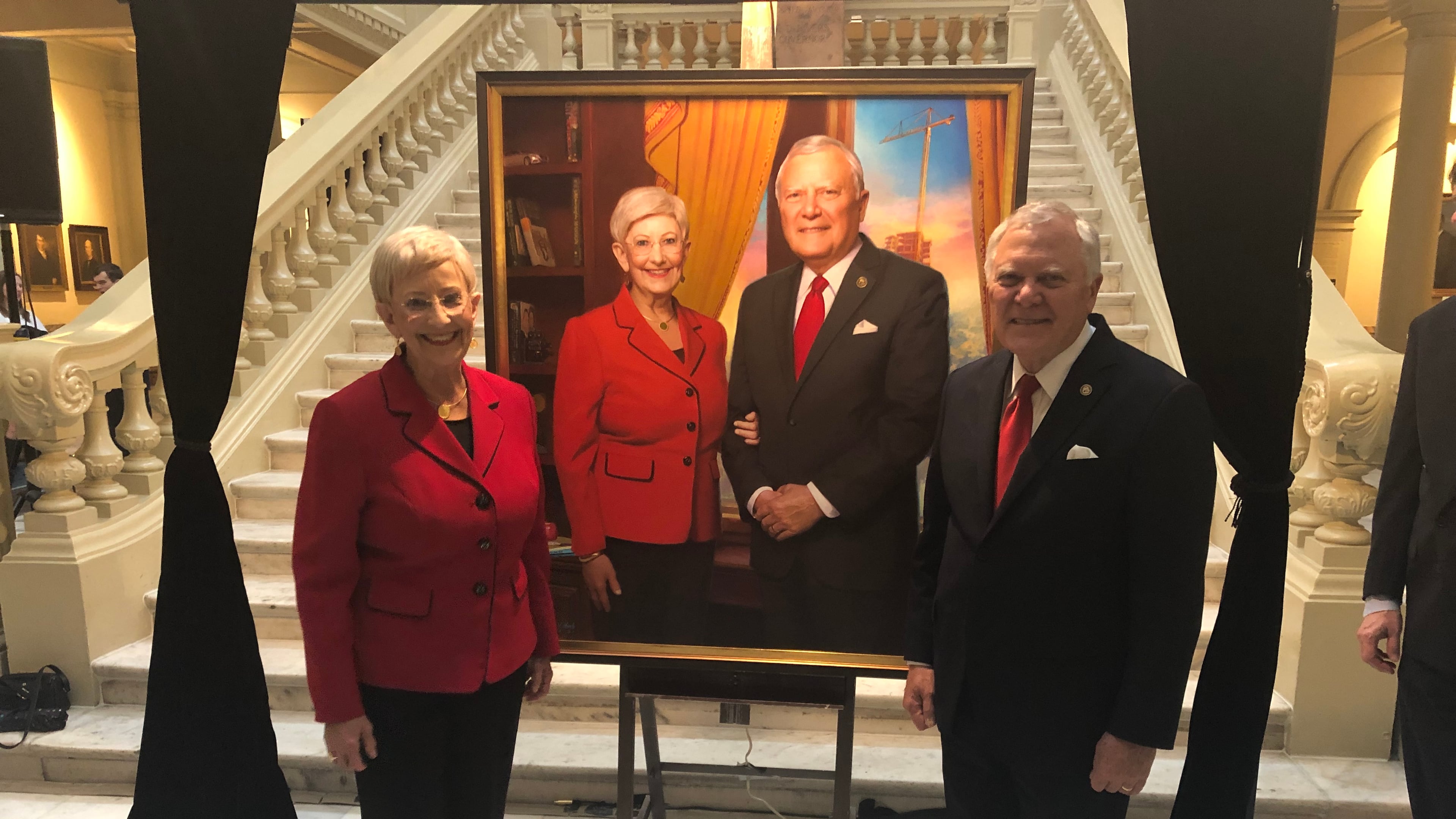 Sandra Deal and Gov. Nathan Deal pose by an official portrait unveiled at the Georgia Capitol. AJC/Greg Bluestein