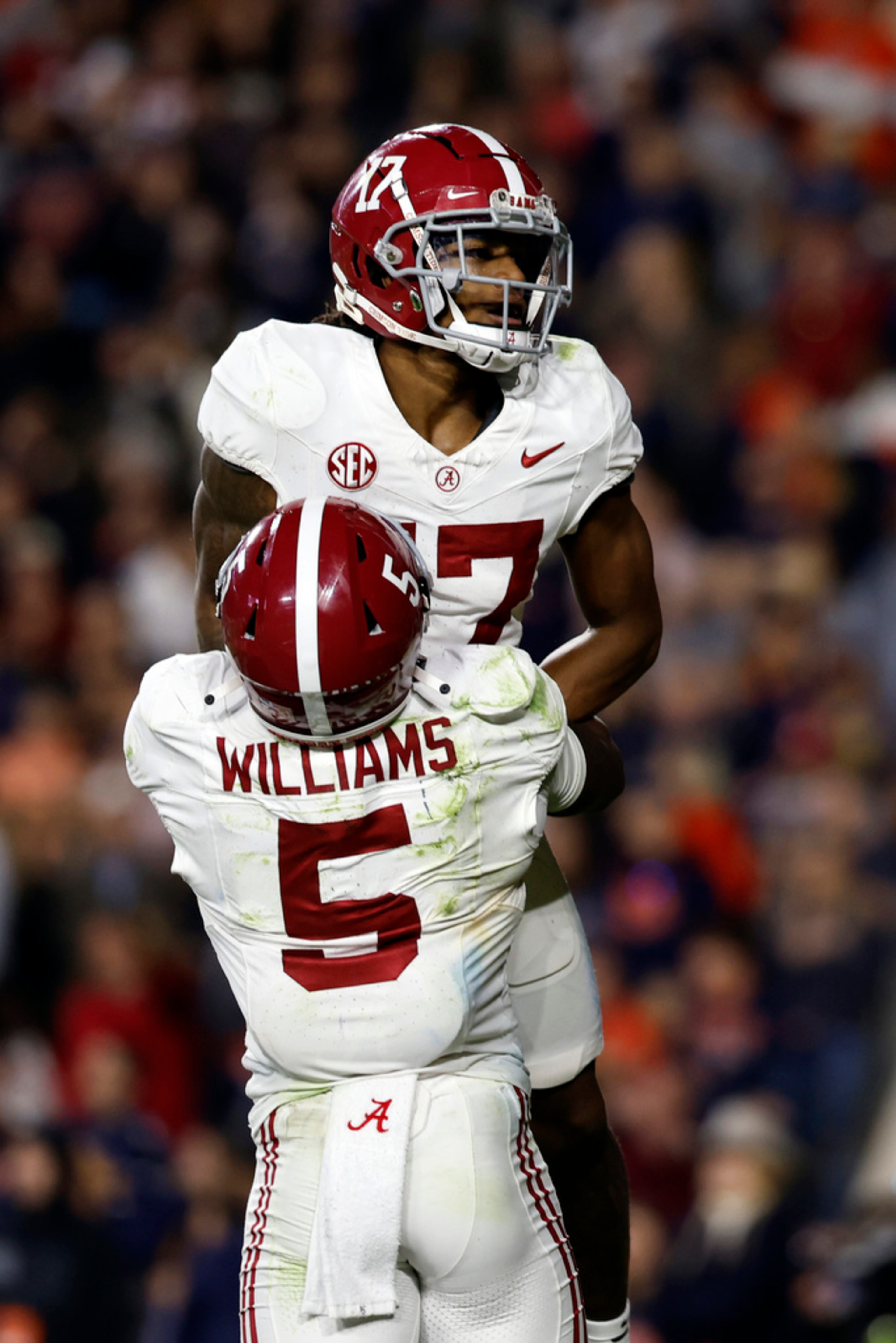 Alabama wide receiver Isaiah Bond (17) celebrates with running back Roydell Williams (5) after catching the winning touchdown pass to defeat Auburn in an NCAA college football game Saturday, Nov. 25, 2023, in Auburn, Ala. (AP Photo/Butch Dill)