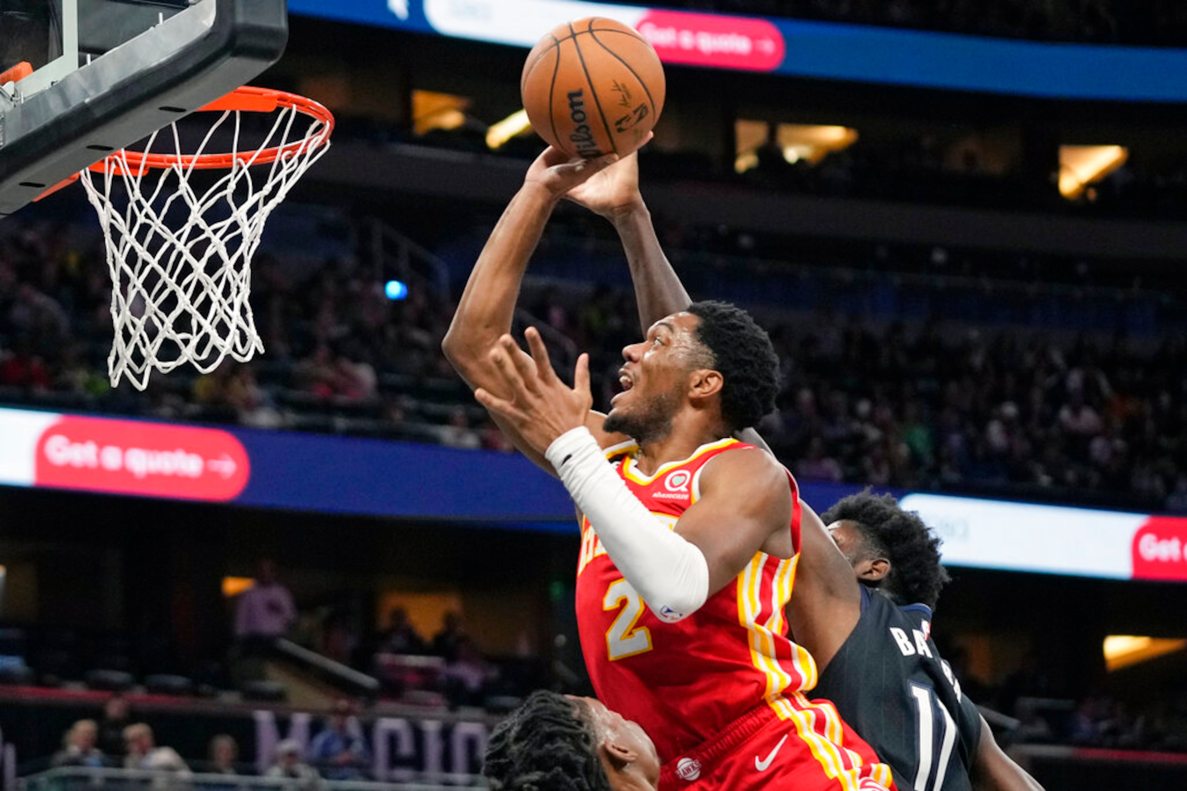 Atlanta Hawks' Trent Forrest (2) goes up for a shot against Orlando Magic's Mo Bamba, right, during the first half of an NBA basketball game, Wednesday, Dec. 14, 2022, in Orlando, Fla. (AP Photo/John Raoux)