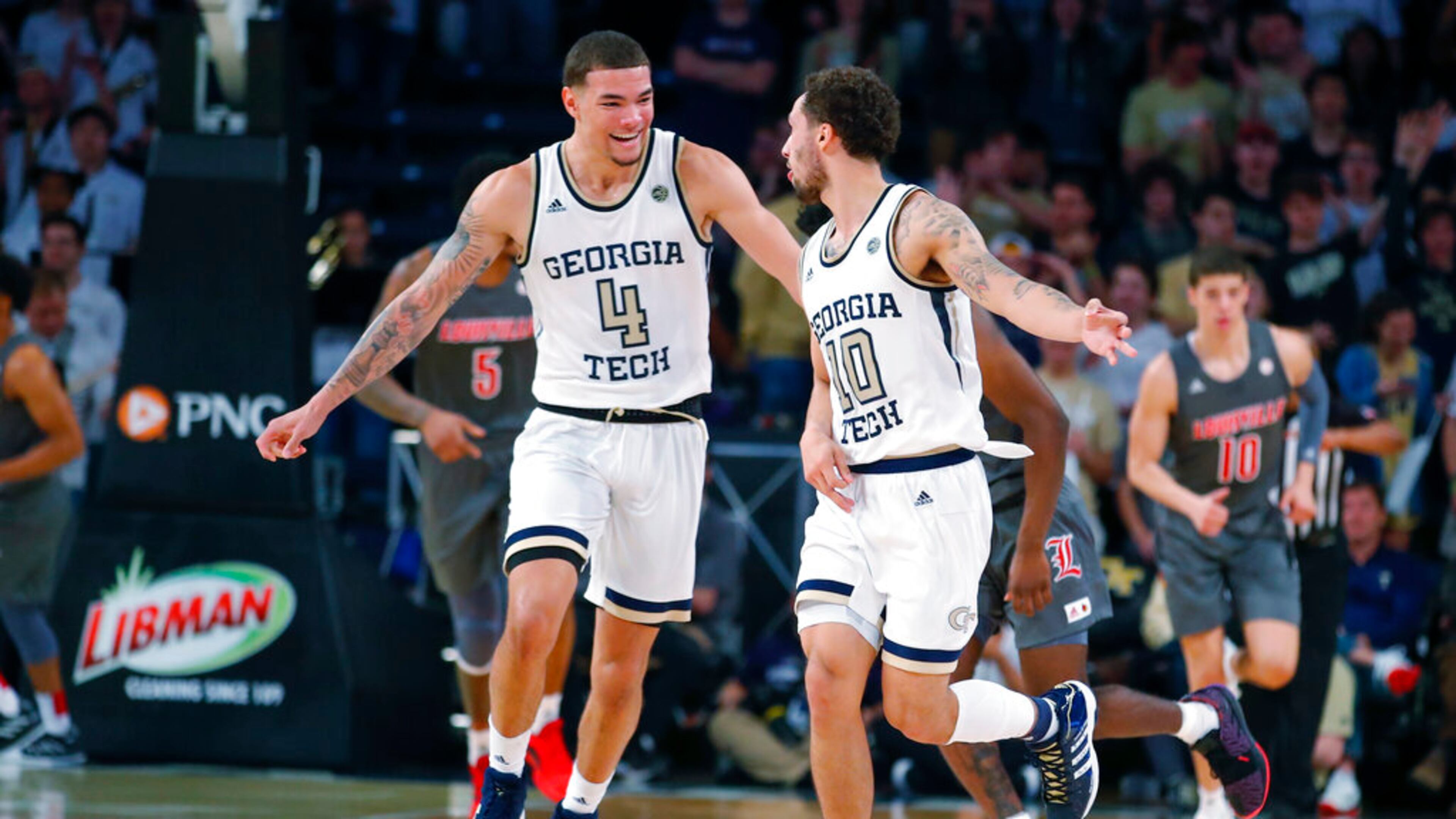 Georgia Tech guard Jordan Usher (4) reacts with guard Jose Alvarado (10) during the first half of an NCAA college basketball game against Louisville in Atlanta, Wednesday, Feb. 12, 2020. (AP Photo/Todd Kirkland)