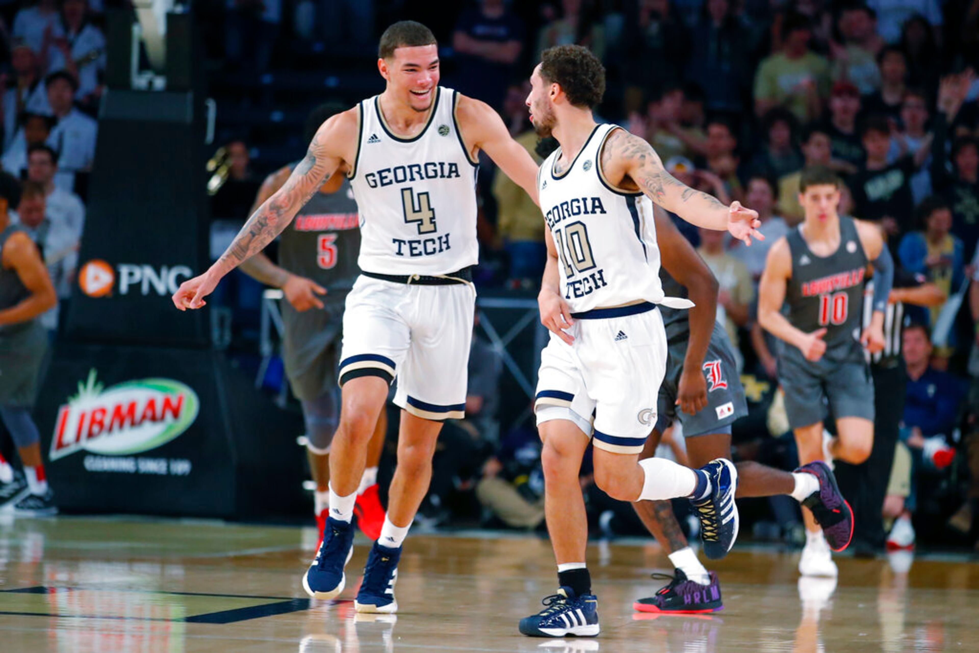 Georgia Tech guard Jordan Usher (4) reacts with guard Jose Alvarado (10) during the first half of an NCAA college basketball game against Louisville in Atlanta, Wednesday, Feb. 12, 2020. (AP Photo/Todd Kirkland)