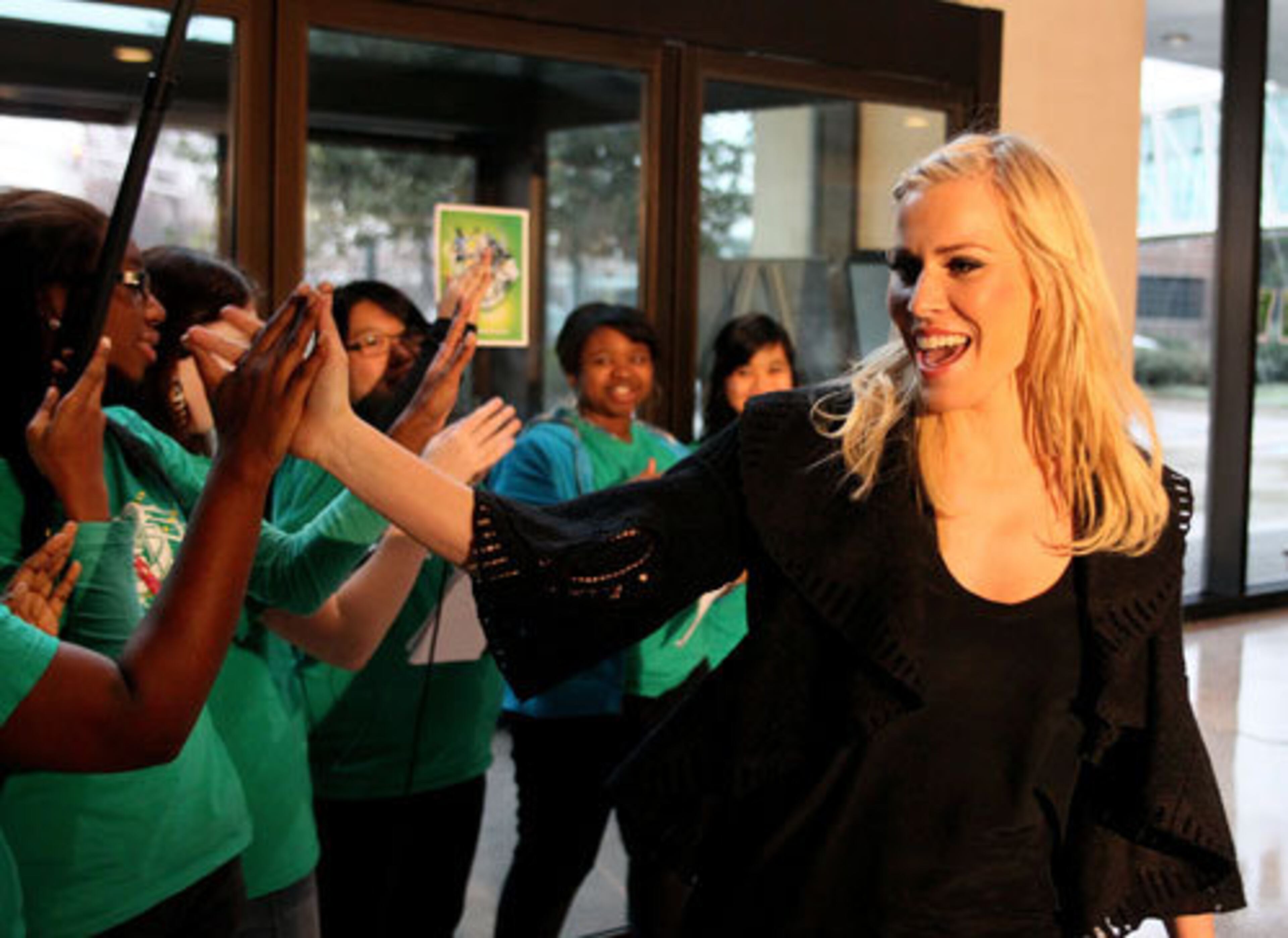British pop star Natasha Bedingfield high-fives crew members at the end of rehearsals.