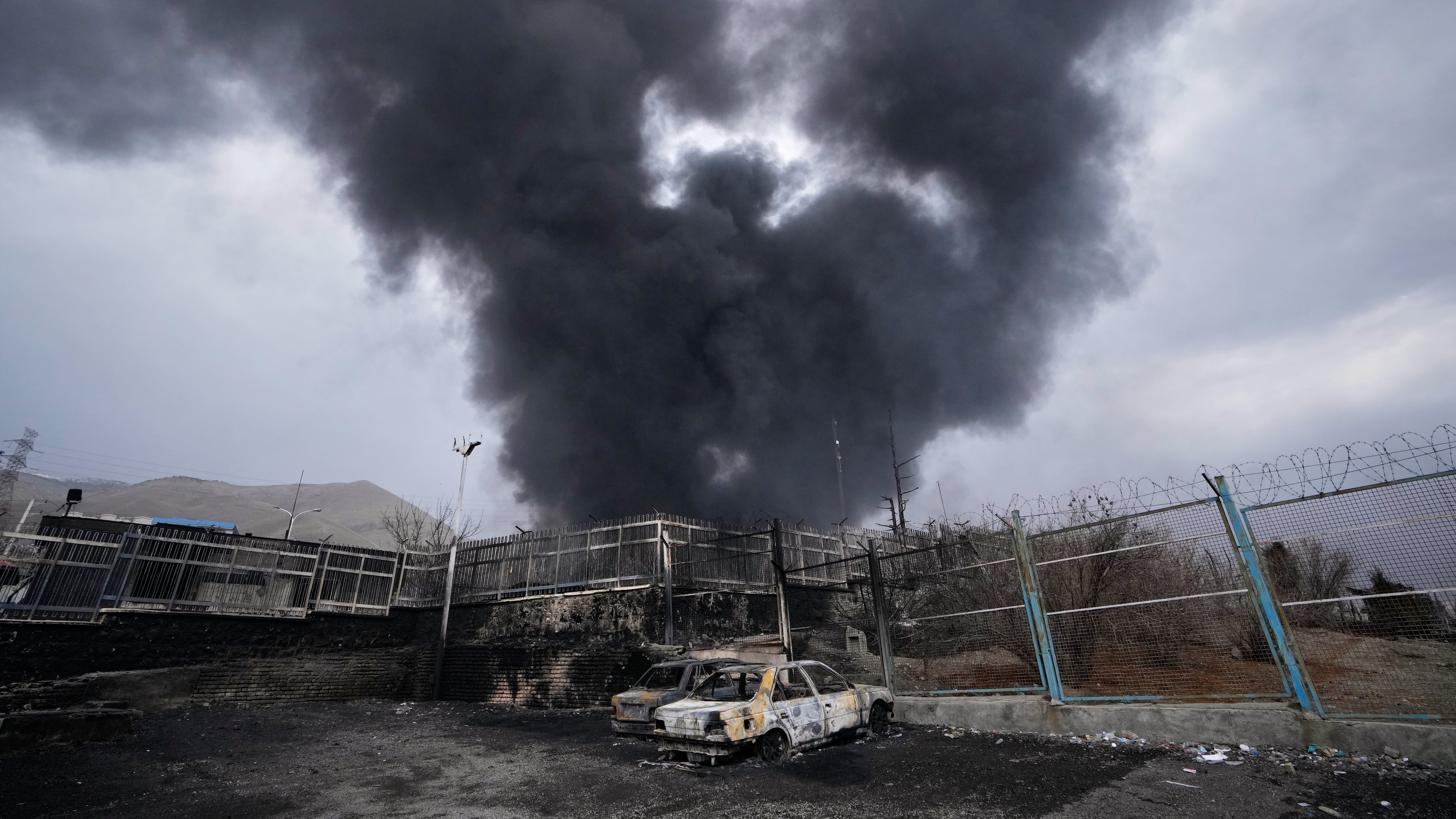 A thick plume of smoke rises from an oil storage facility hit by a U.S.-Israeli strike late Saturday in Tehran, Iran, Sunday, March 8, 2026. (AP Photo/Vahid Salemi)