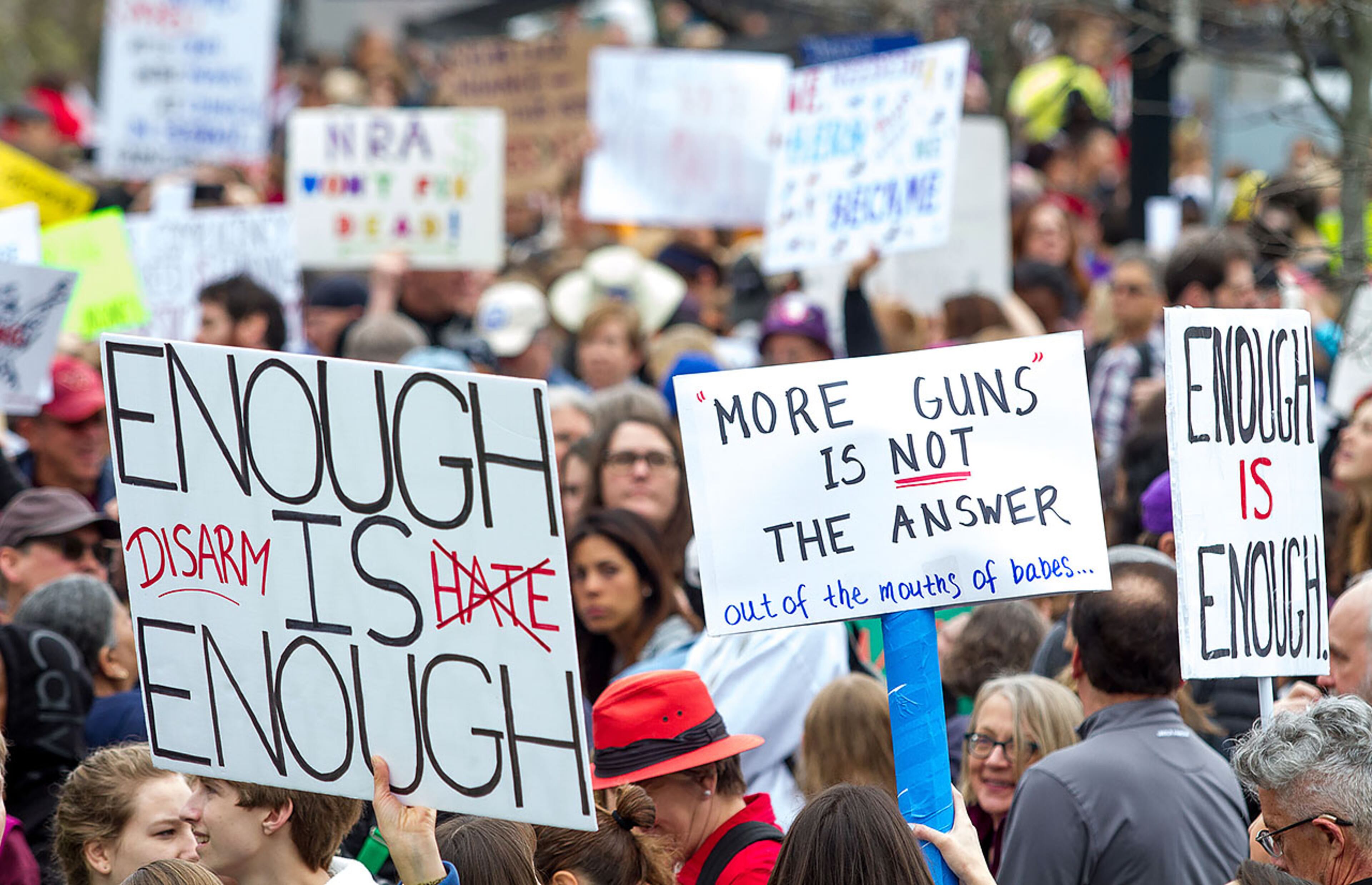 People and signs fill a gathering area in front of the Center for Civil and Human Rights building before the start of the March For Our Life Atlanta rally Saturday, March 24, 2018, The Atlanta police department estimated the crowd at near 30,000 people. STEVE SCHAEFER / SPECIAL TO THE AJC