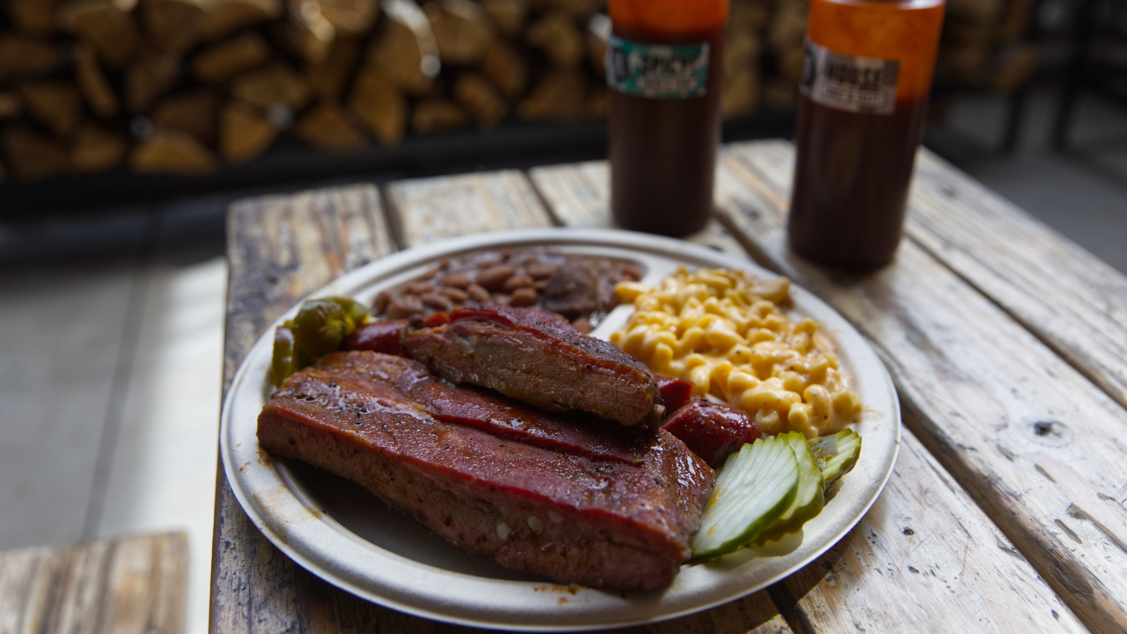 A plate of ribs and sausage with two sides is served at the Little Miss BBQ in Phoenix, Tuesday May 19, 2026. (AP Photo/Dario Lopez-Mills)