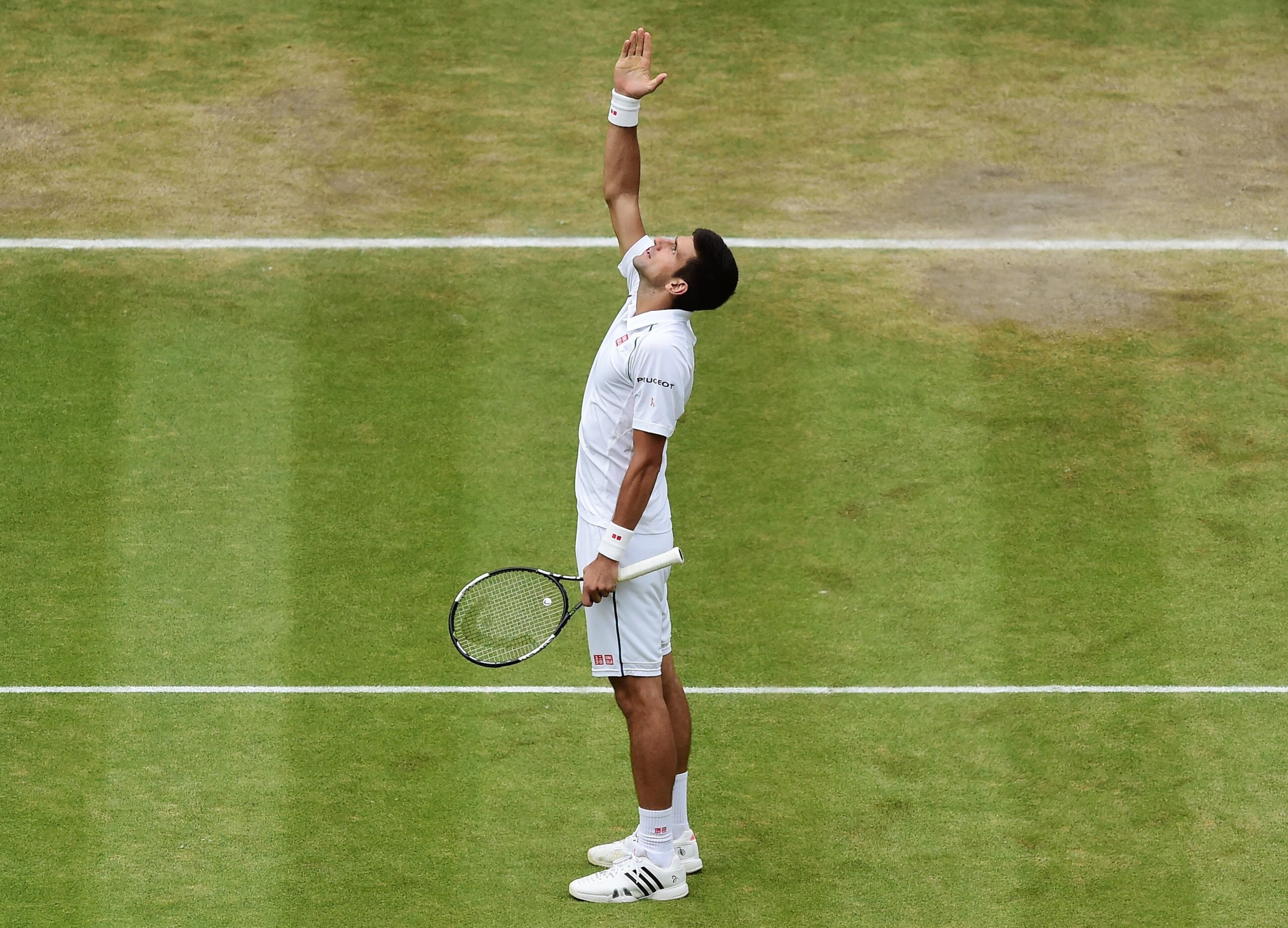 LONDON, ENGLAND - JULY 12: Novak Djokovic celebrates with the trophy after victory over Roger Federer of Switzerland in the Gentleman's Singles Final during day thirteen of the Wimbledon Lawn Tennis Championships at the All England Lawn Tennis and Croquet Club on July 12, 2015 in London, England. (Photo by Alex Broadway/Anadolu Agency/Getty Images)