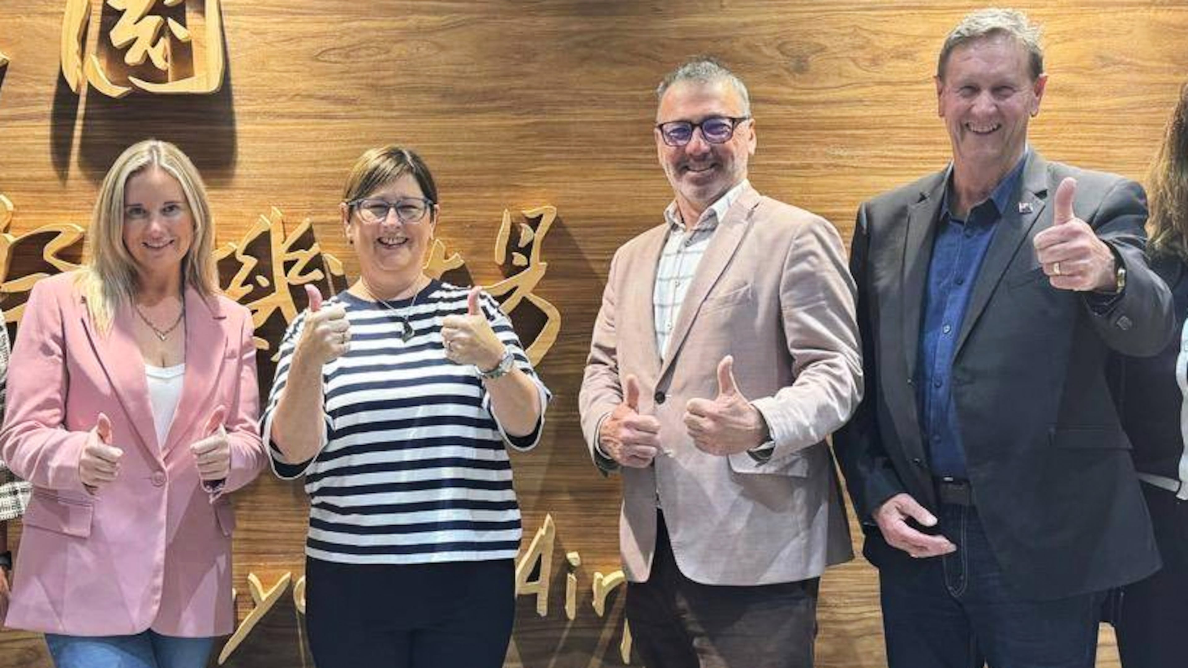 In this image supplied by the Taiwan Ministry of Foreign Affairs (MOFA), New Zealand lawmakers from left, Laura McClure, Maureen Pugh, Duncan Webb and David Wilson gesture as they pose for a photo at Taiwan Taoyuan International Airport, on May 4, 2026. (Taiwan MOFA via AP)