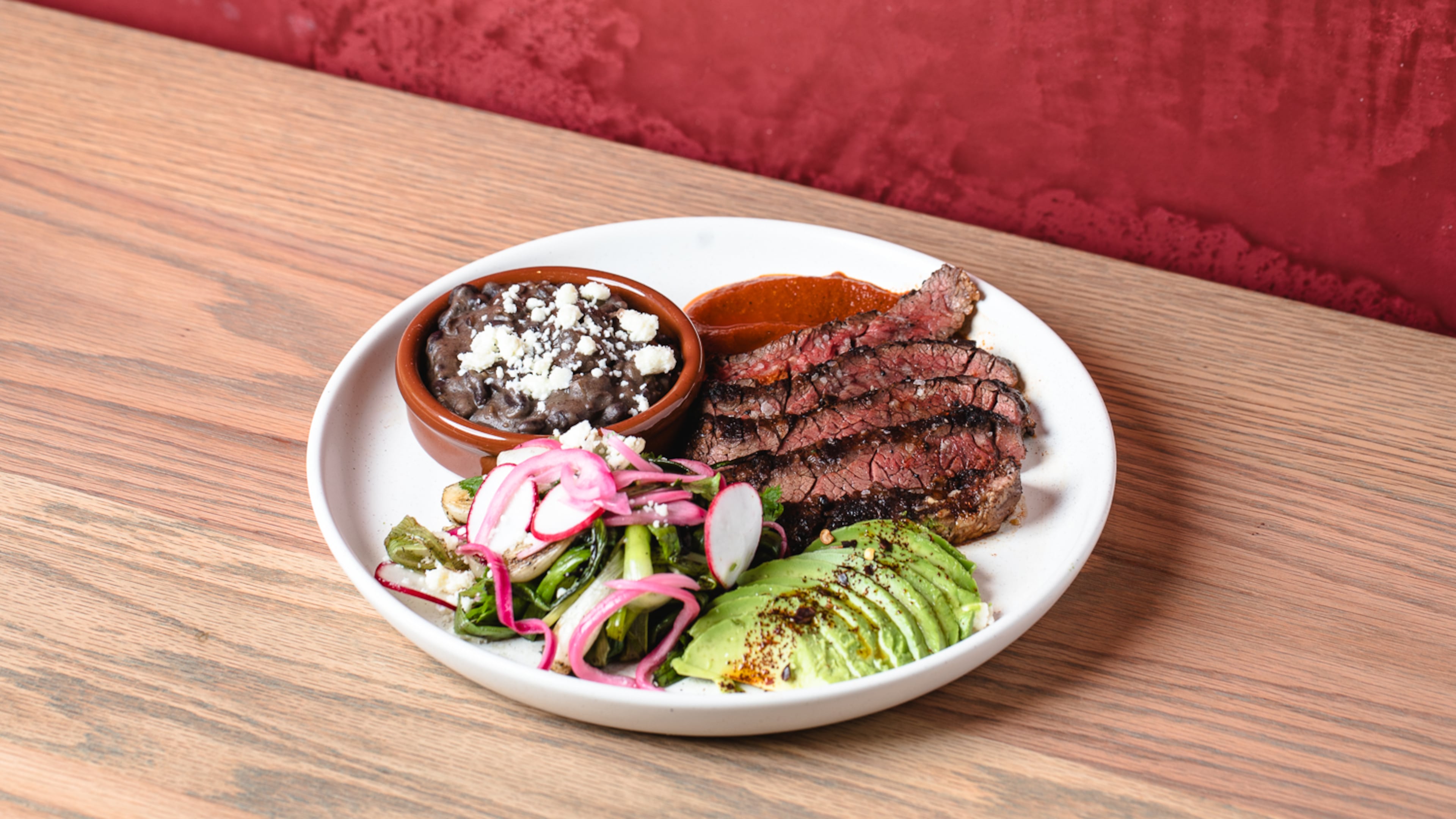 Carne asada with guajillo salsa, avocado, radish, black beans and tortillas from the Chicheria MX Kitchen menu.