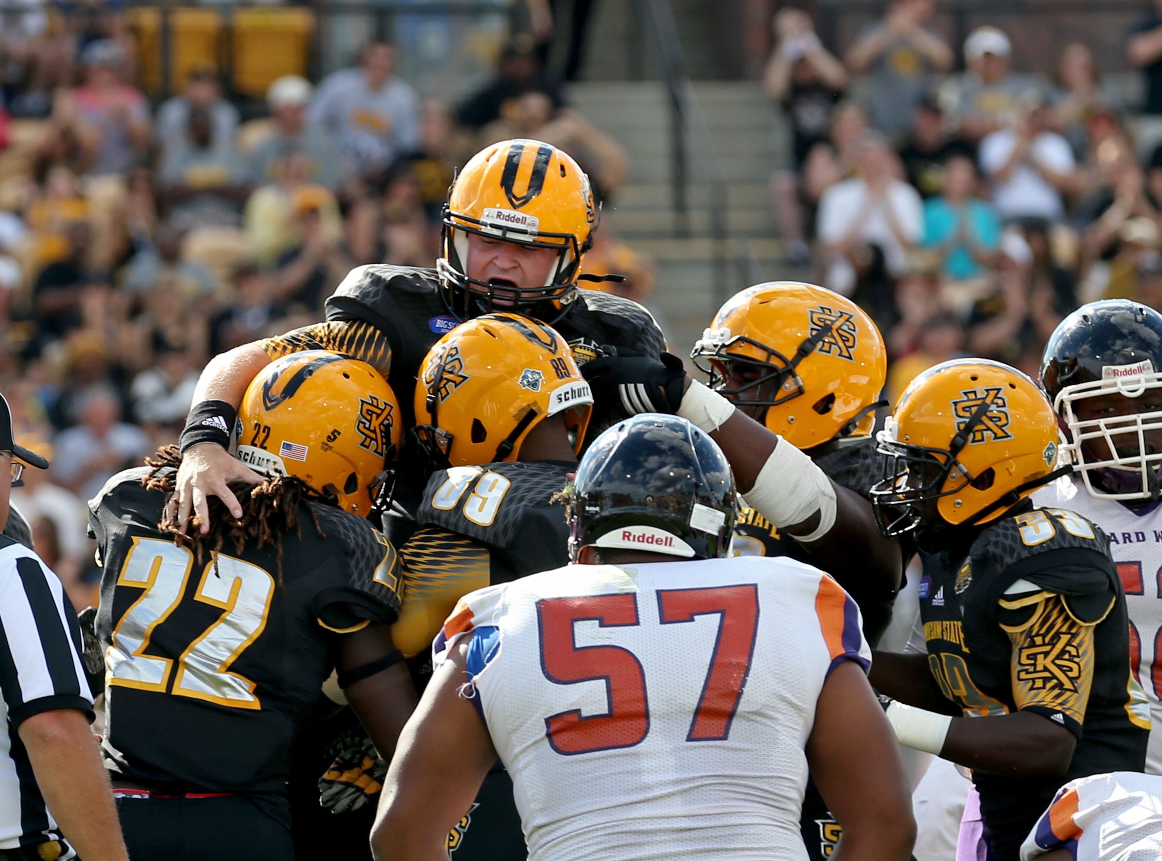 September 12, 2015 - Kennesaw, Ga: Kennesaw State University quarterback Trey White (10, top) celebrates his second rushing touchdown with teammates in the first quarter of their game against Edward Waters at Fifth Third Bank Stadium, Saturday, September 12, 2015, in Kennesaw, Ga.. This is the first home game of KSU's inaugural football season. PHOTO / JASON GETZ