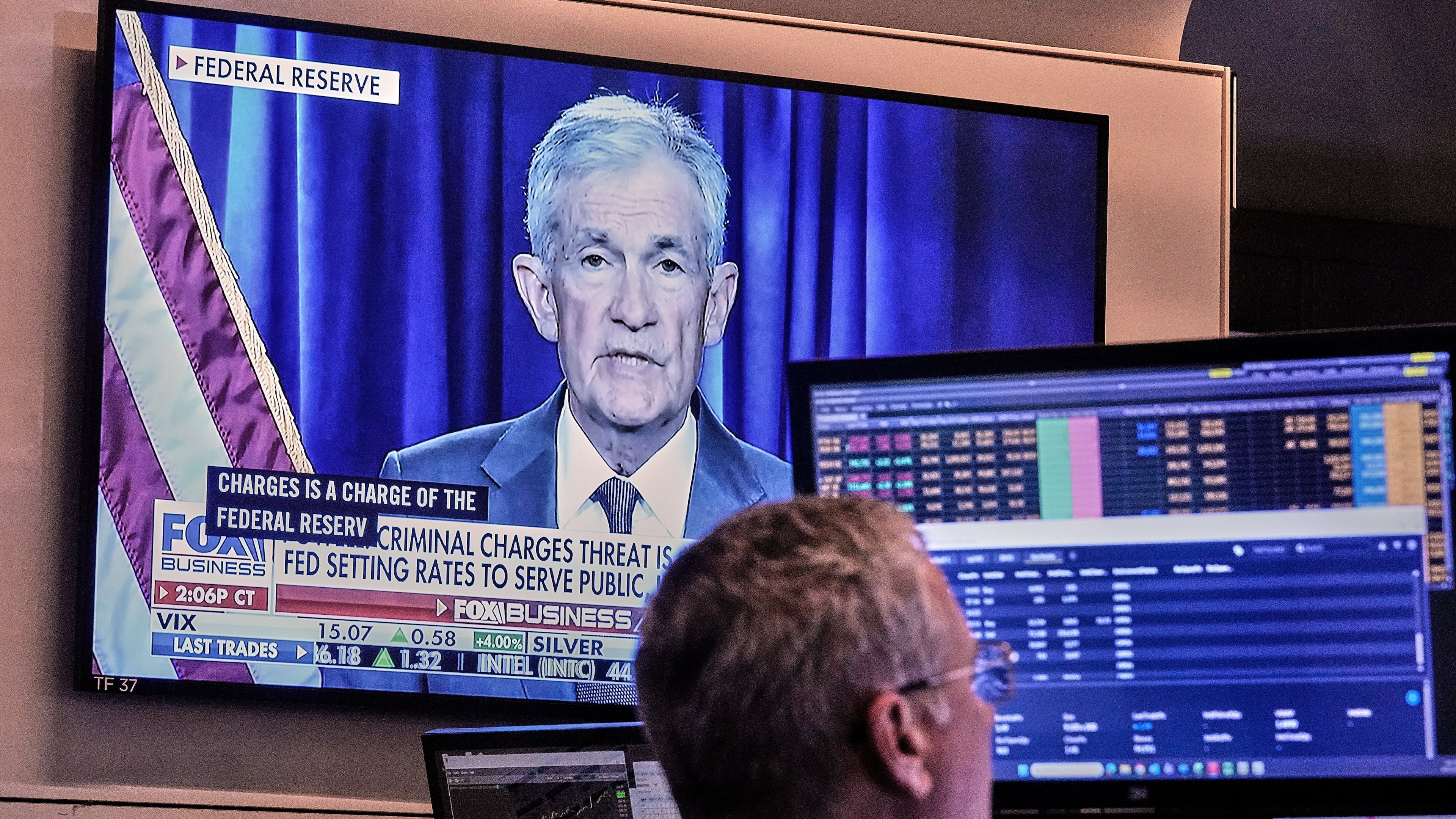 A video of Federal Reserve Chair Jerome Powell plays on a screen on the floor of the New York Stock Exchange, Monday, Jan. 12, 2026. (AP Photo/Richard Drew)