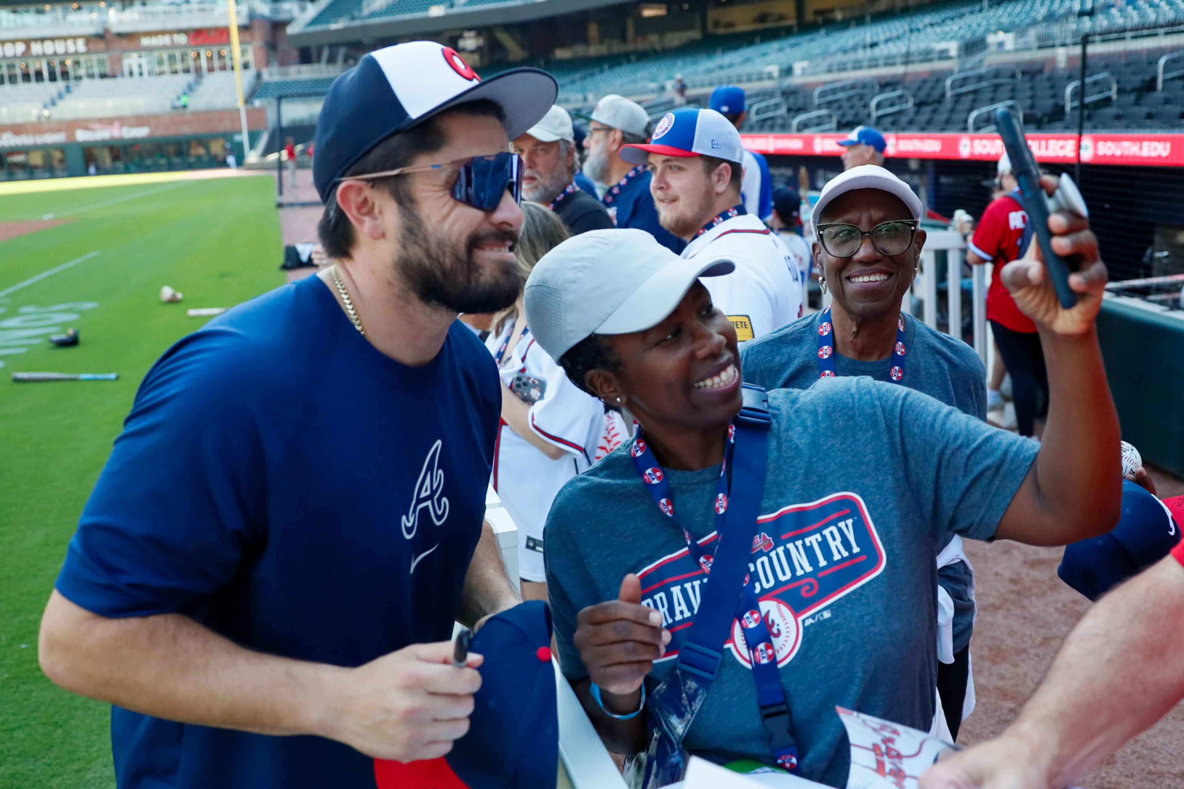 Rhonda Pearson, from South Carolina, takes a selfie with Atlanta Braves catcher Travis d’Arnaud (16) while her mother, Joann Pearson, looked on just before the game between the Atlanta Braves and the Colorado Rockies at Truist Park on Tuesday, September 3, 2024, in Atlanta.
(Miguel Martinez/ AJC)