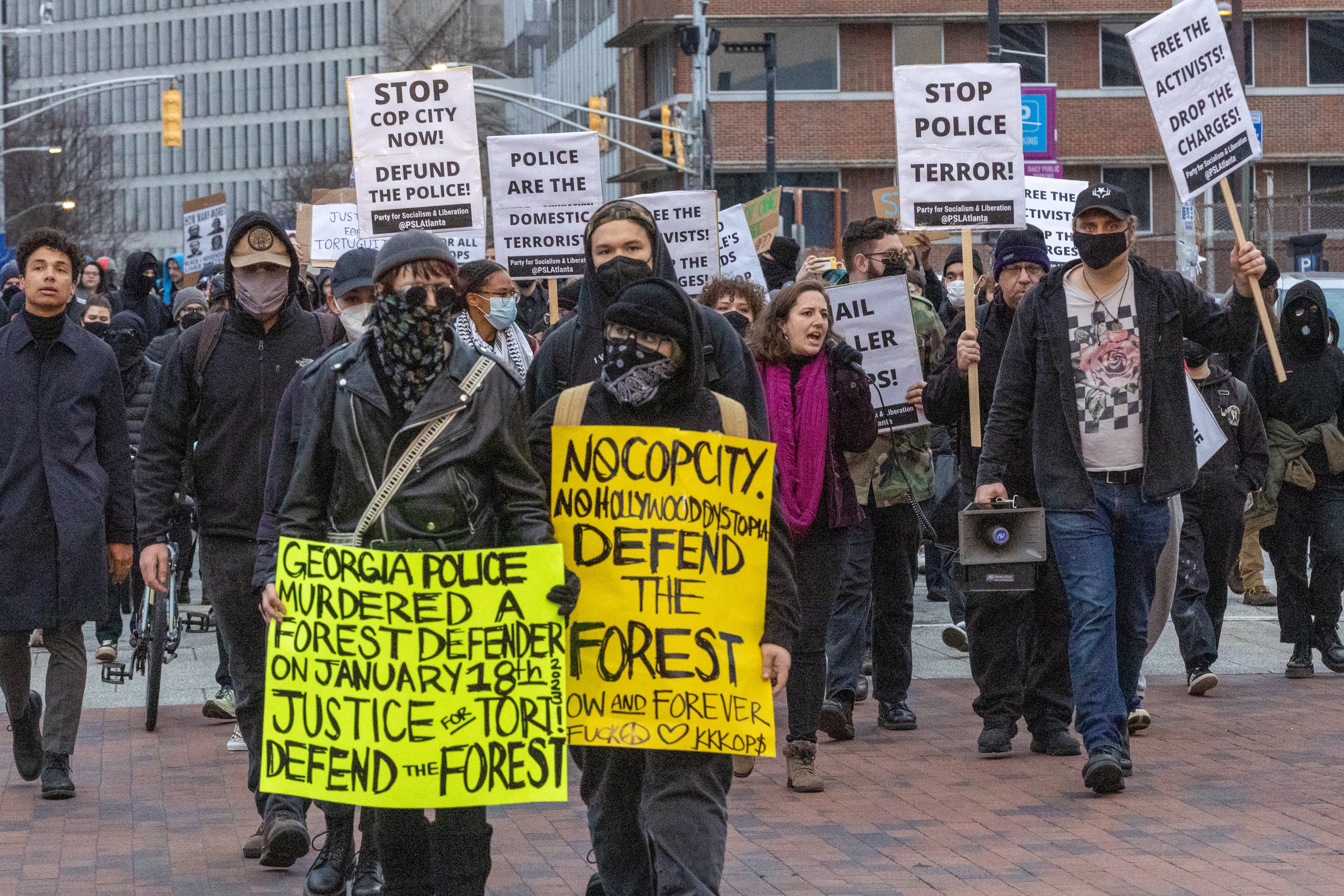 Forest Defender protesters march in the streets near Underground Atlanta on Saturday. The Atlanta Police Department said several people were arrested after a police car was set afire. (Steve Schaefer/steve.schaefer@ajc.com)
