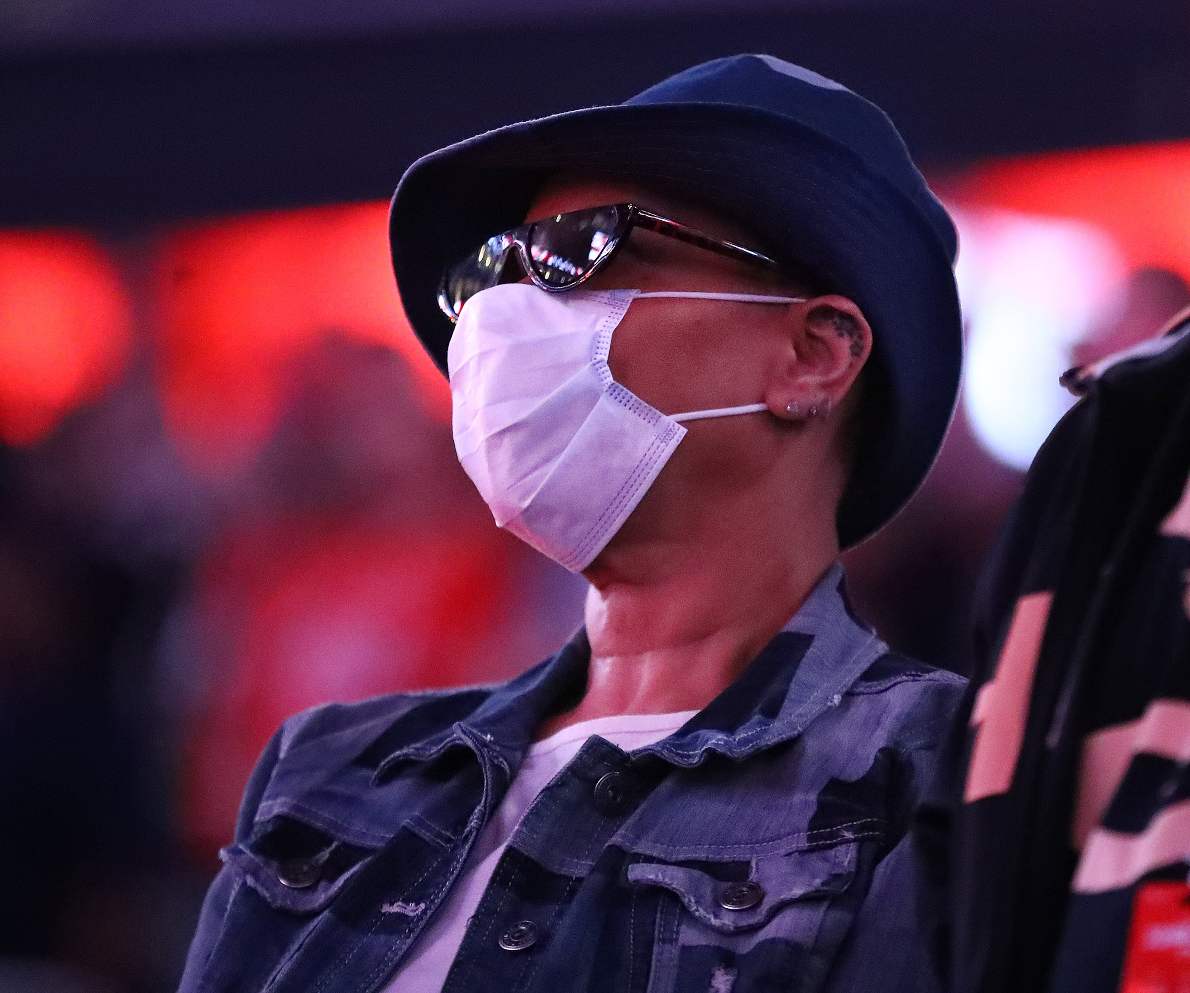 Hawks fan Lolita Owens, Snellville, who said she has a impaired immune system, wears a mask for protection from the Coronavirus while watching her team play the New York Knicks in a NBA basketball game on Wednesday, March 11, 2020, in Atlanta. As the country grapples with coronavirus and how to best combat the spread of the disease, athletic teams and organizations are asking themselves that same question. Curtis Compton ccompton@ajc.com