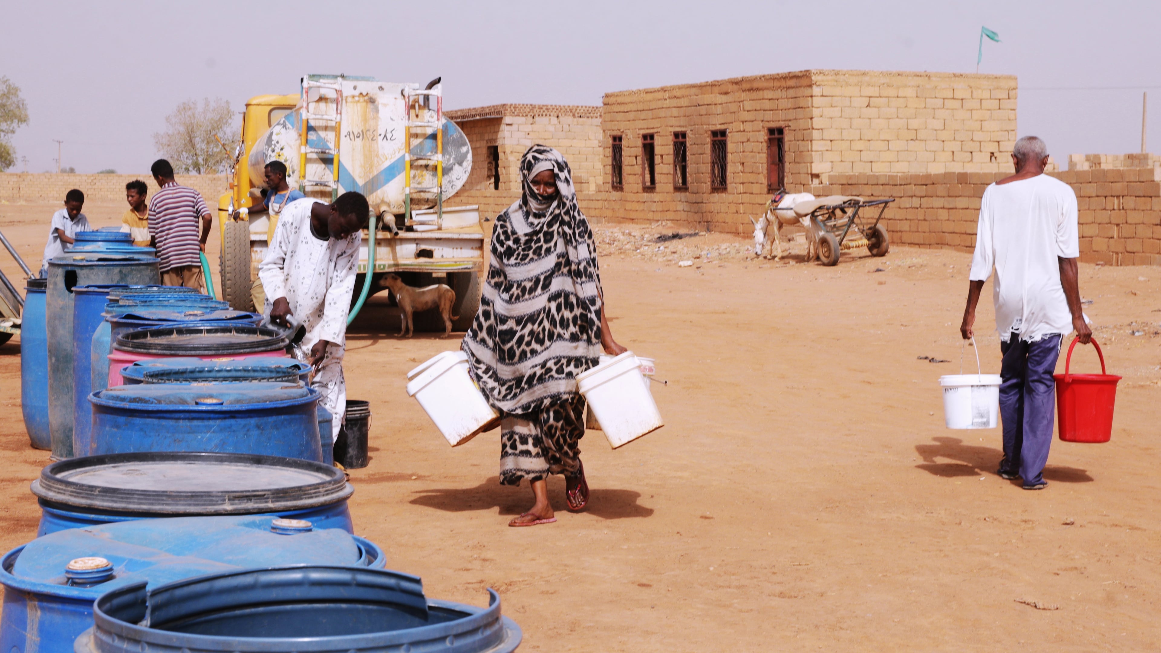 FILE - People fill water containers at a free distribution point amid water outages in Khartoum, Sudan, May 18, 2026. (AP Photo/Marwan Ali, File)